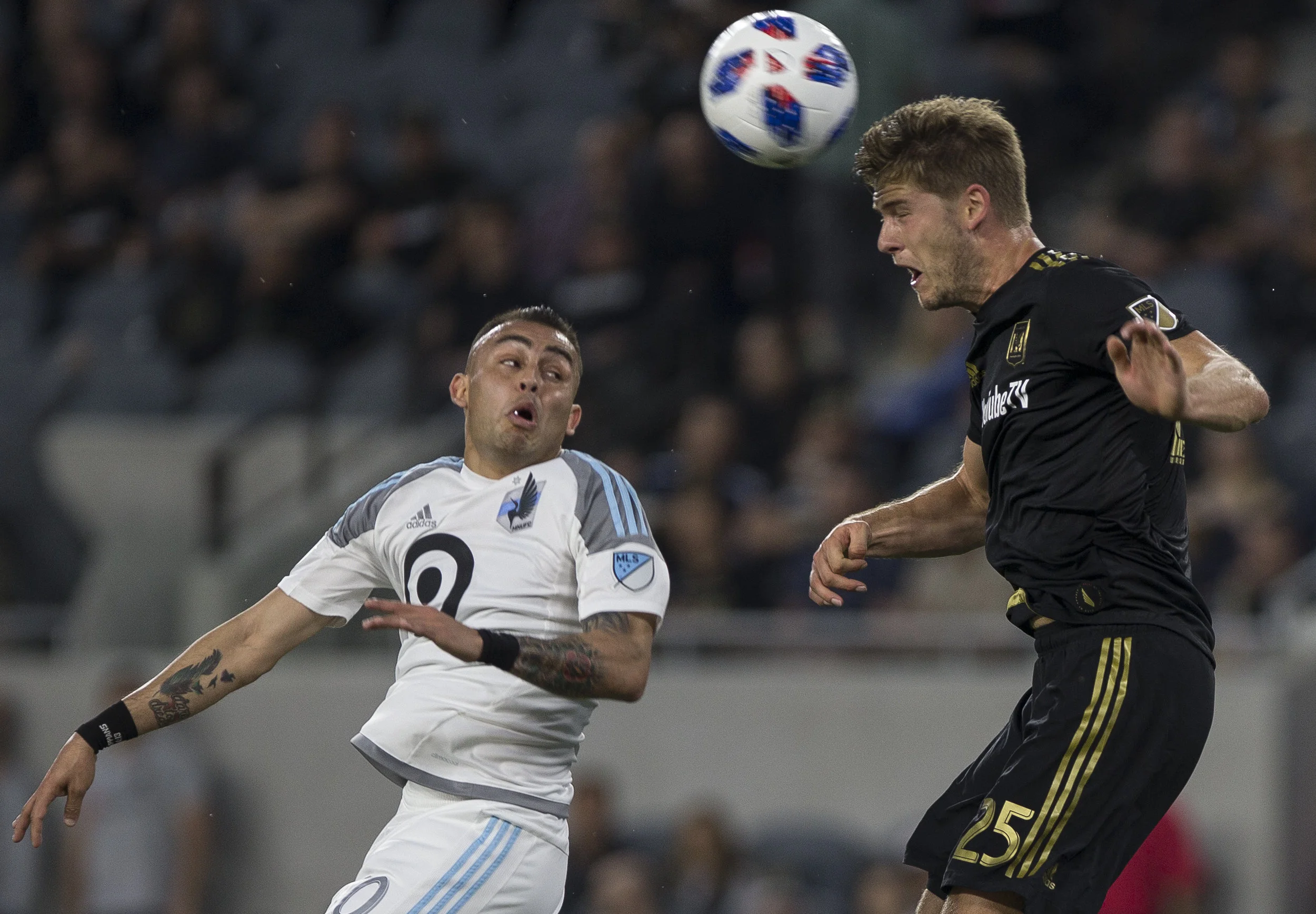 Los Angeles Football Club (LAFC) defender Walker Zimmerman (25, right) headers the ball away from Minnesota United Football Club (MUFC) midfileder Miguel Ibarra (10, left) during their match at Banc of California Stadium on May 9, 2018 where the LAFC won 2-0. (Zane Meyer-Thornton/Corsair Photo)
