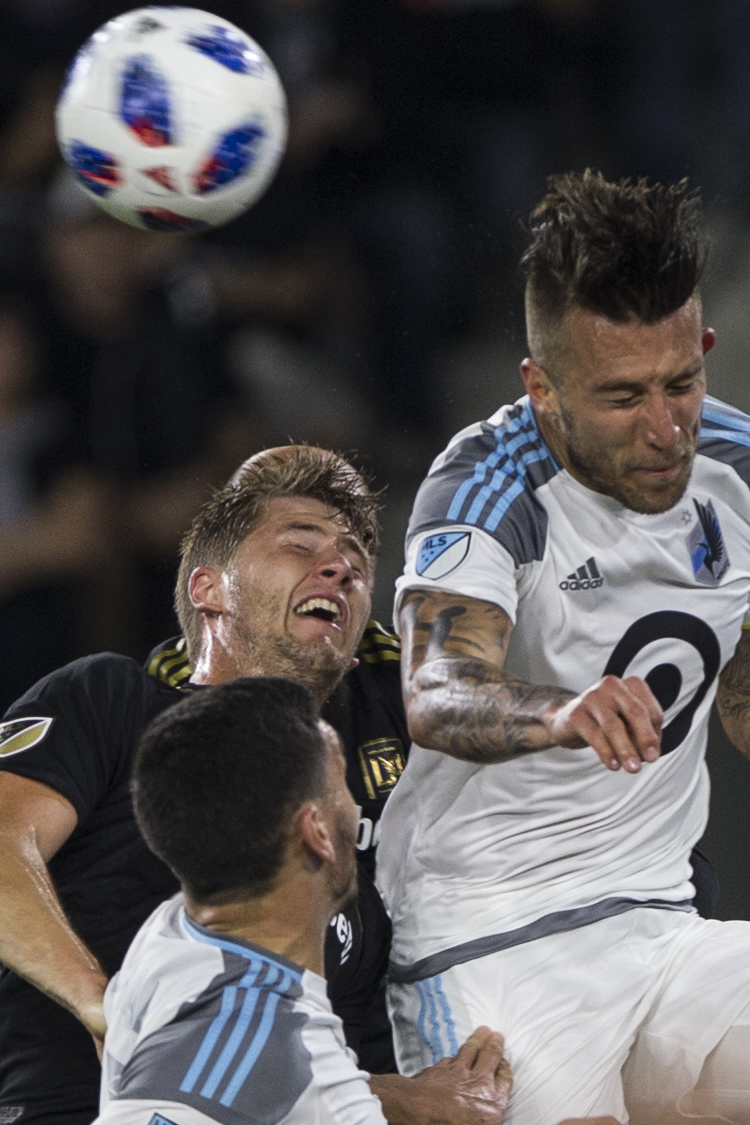  Los Angeles Football Club (LAFC) defender Walker Zimmerman (black, left) battles for a header against Minnesota United Football Club Captain Defender Francisco Calvo (white, right) during their match at Banc of California Stadium on May 9, 2018 wher