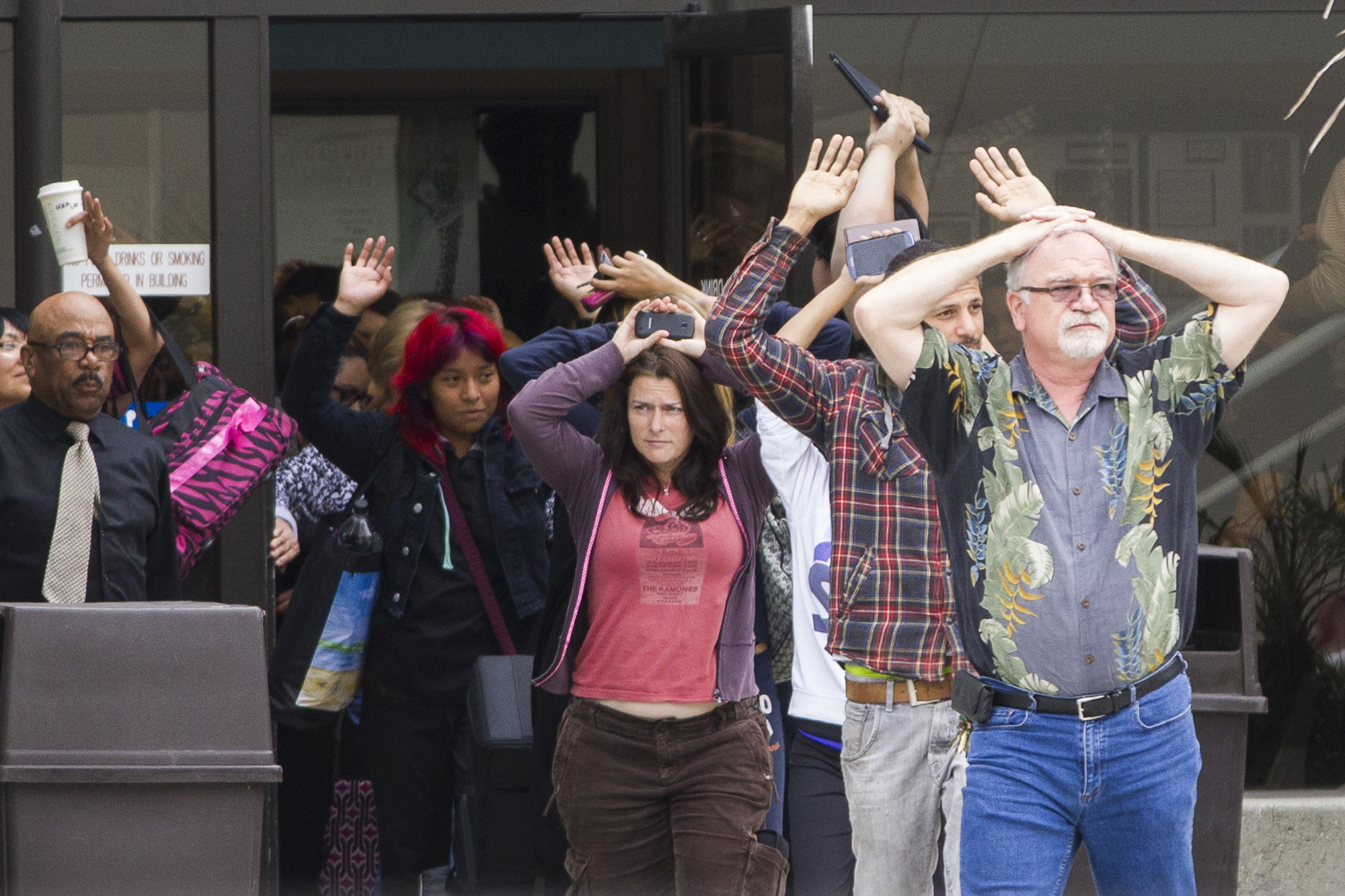  Santa Monica College students, who were in the middle of taking final exams, evacuate from the business building on the Santa Monica College main campus with Professor Bob Ware leading them out during the violent tragedy where six people were killed