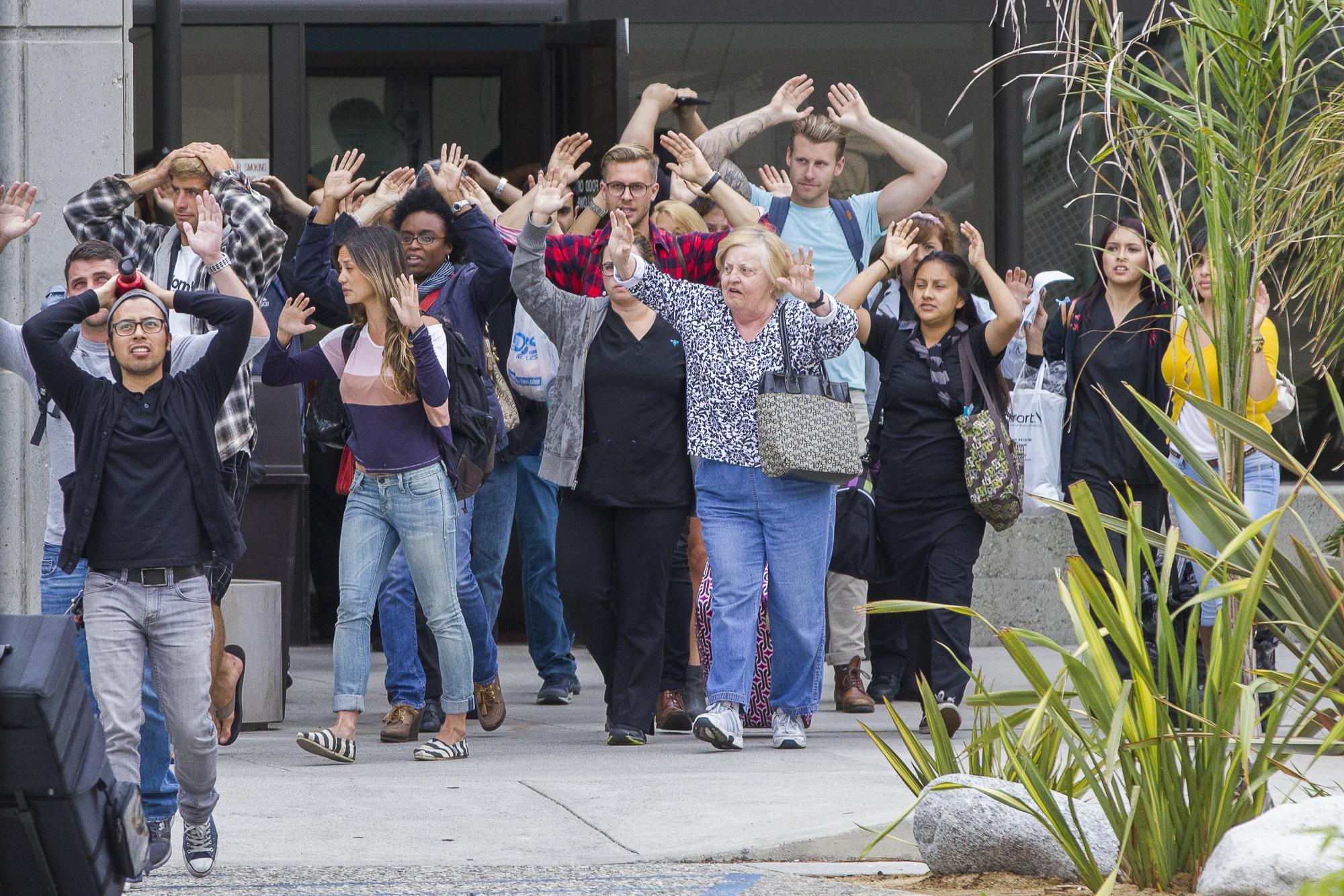  Students are ordered to evacute from the Business Building with their hands in the air while officers direct riffles in their direction to secure the scene during a school shooting on June 7, 2013 at Santa Monica College in Santa Monica, California.