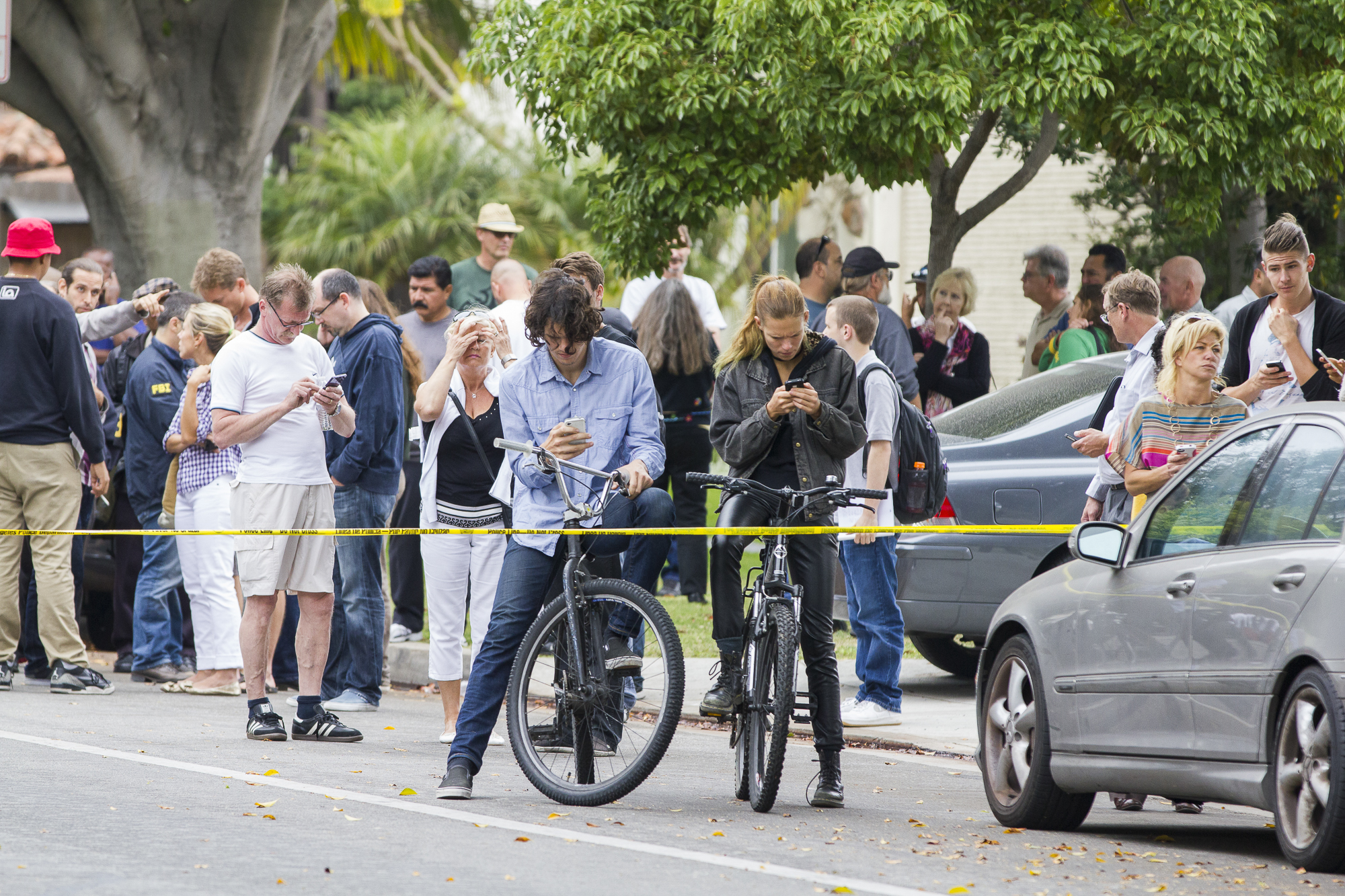  Students evacuated from the main campus at Santa Monica College during the tragic shooting on June 7, 2013, gather on Pearl Street just west of 16th street and join other concerned onlookers behind the police tape. (Jose Lopez/Corsair Contributor) 