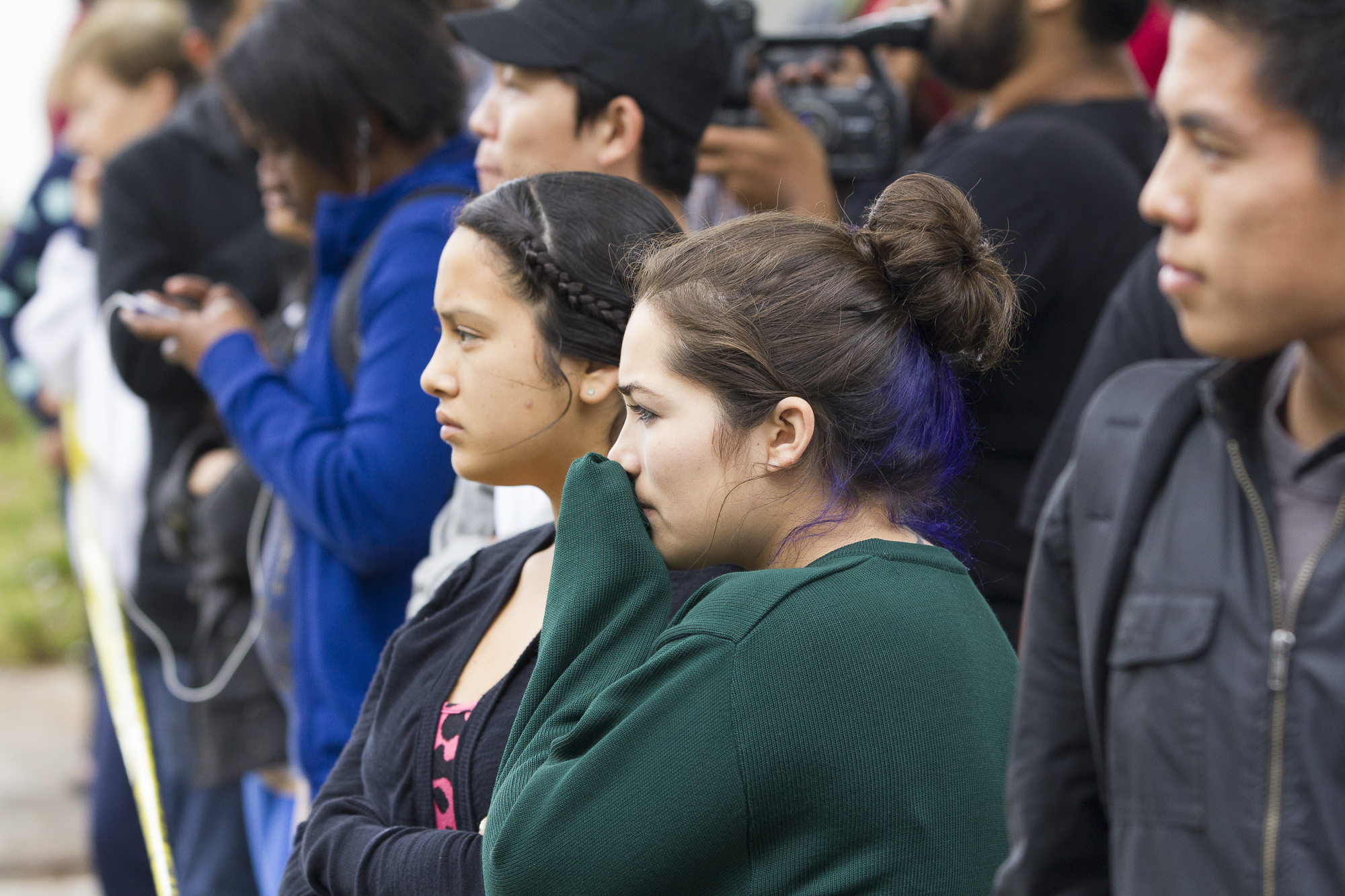  Students evacuated from the main campus of Santa Monica College during the tragic shooting gather on Pearl Street just west of 16th street and join other concerned onlookers behind the police tape on June 7, 2013 in Santa Monica, California. Six peo