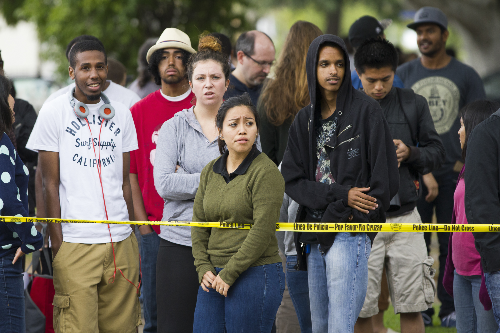 Students evacuated from the main campus of Santa Monica College during the tragic shooting gather on Pearl Street just west of 16th street and join other concerned onlookers behind the police tape on June 7, 2013 in Santa Monica, California. Six peo