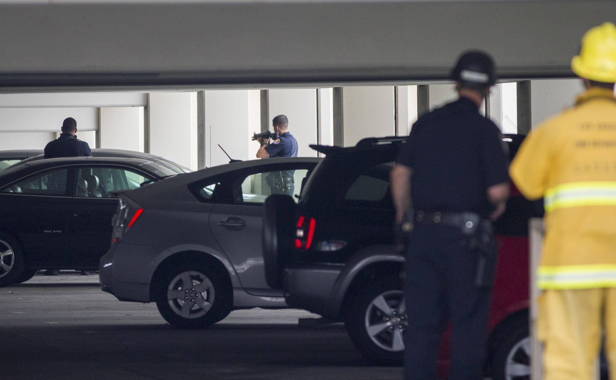  Law enforcement officers search for a suspect during a shooting on the main campus of Santa Monica College in the parking structure off of Pico Blvd near the business building in Santa Monica, California. Six people were killed including the gunman.