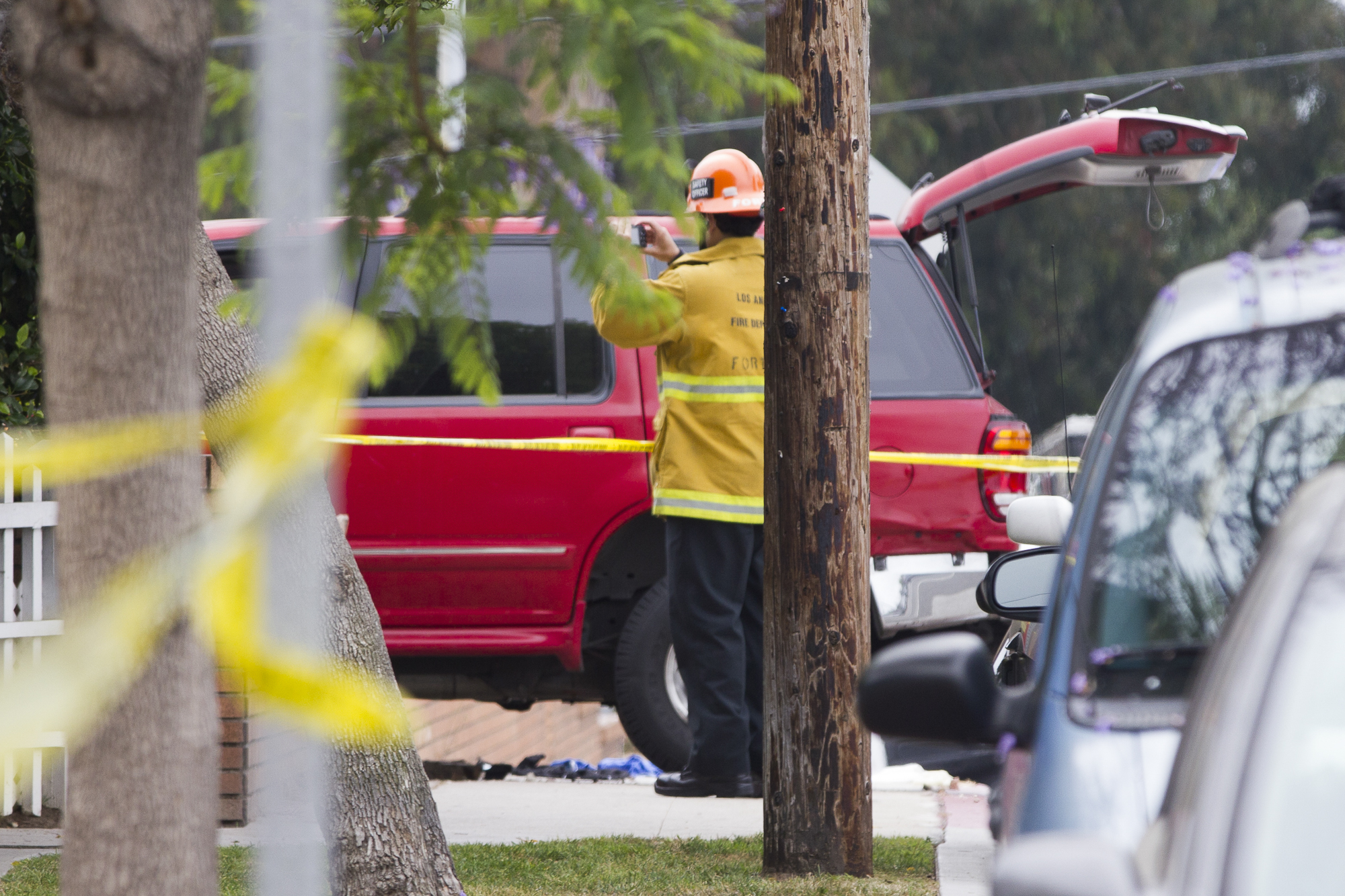  Fire department personnel investigate one of the vehicles involved in the Santa Monica College shooting at the main campus off of Pearl Street on June 7, 2013 in Santa Monica, California. The vehicle was determined to belong to shooting victims, Car