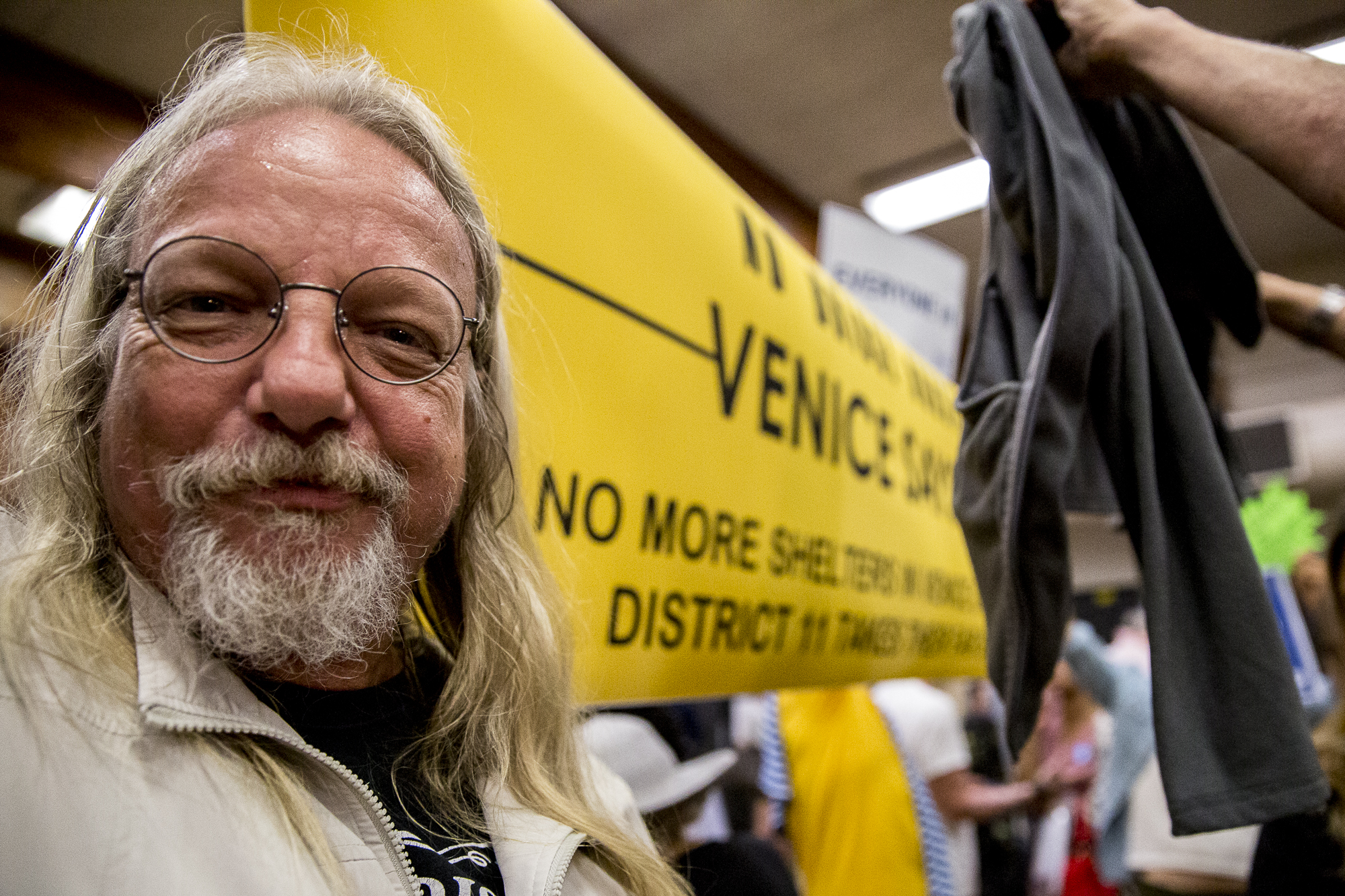  James Harmsworth helps hold a banner that reads “Venice Says No!” during the Town Hall that had local Venice residents discussing why they are either for or against the building of a homeless shelter at the former metro bus lot at 100 E. Sunset in V