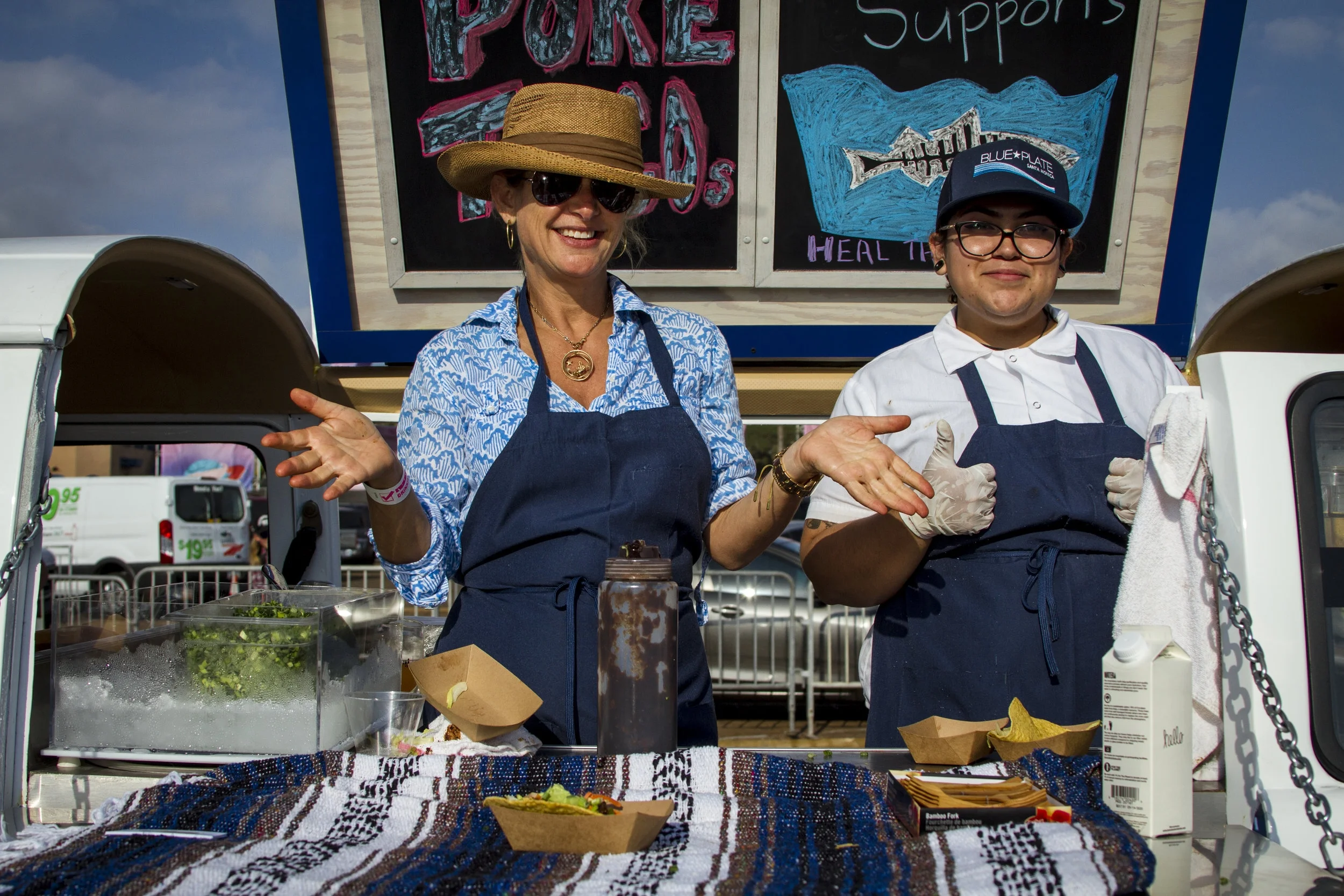 Jennifer Rush (left) and Selenia Melendez (right) hand out ahi tuna taco from their mobile van. At the Off the Hook Seafood Festival. Oct. 6, 2018. By Yasser Marte.