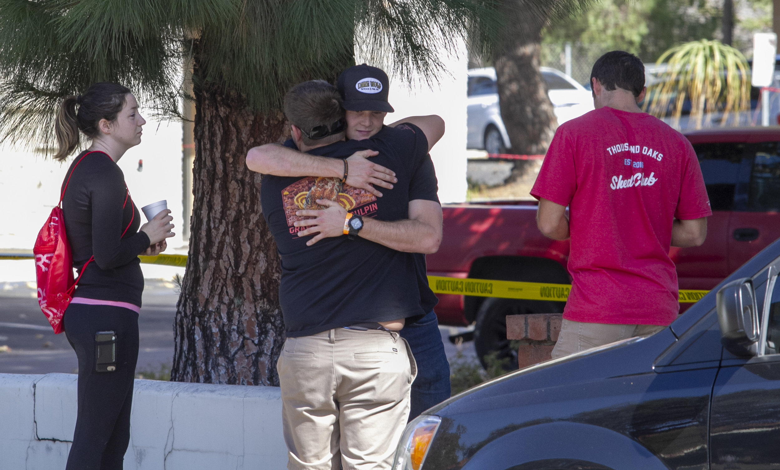  People comfort each other while waiting to speak to authorities. Ian David Long, 28, killed at least 13 and injured more than a dozen at Borderline Bar &amp; Grill in Thousand Oaks, CA on Wednesday, Nov. 7 2018. (Andrew Navarro/ Corsair Staff) 