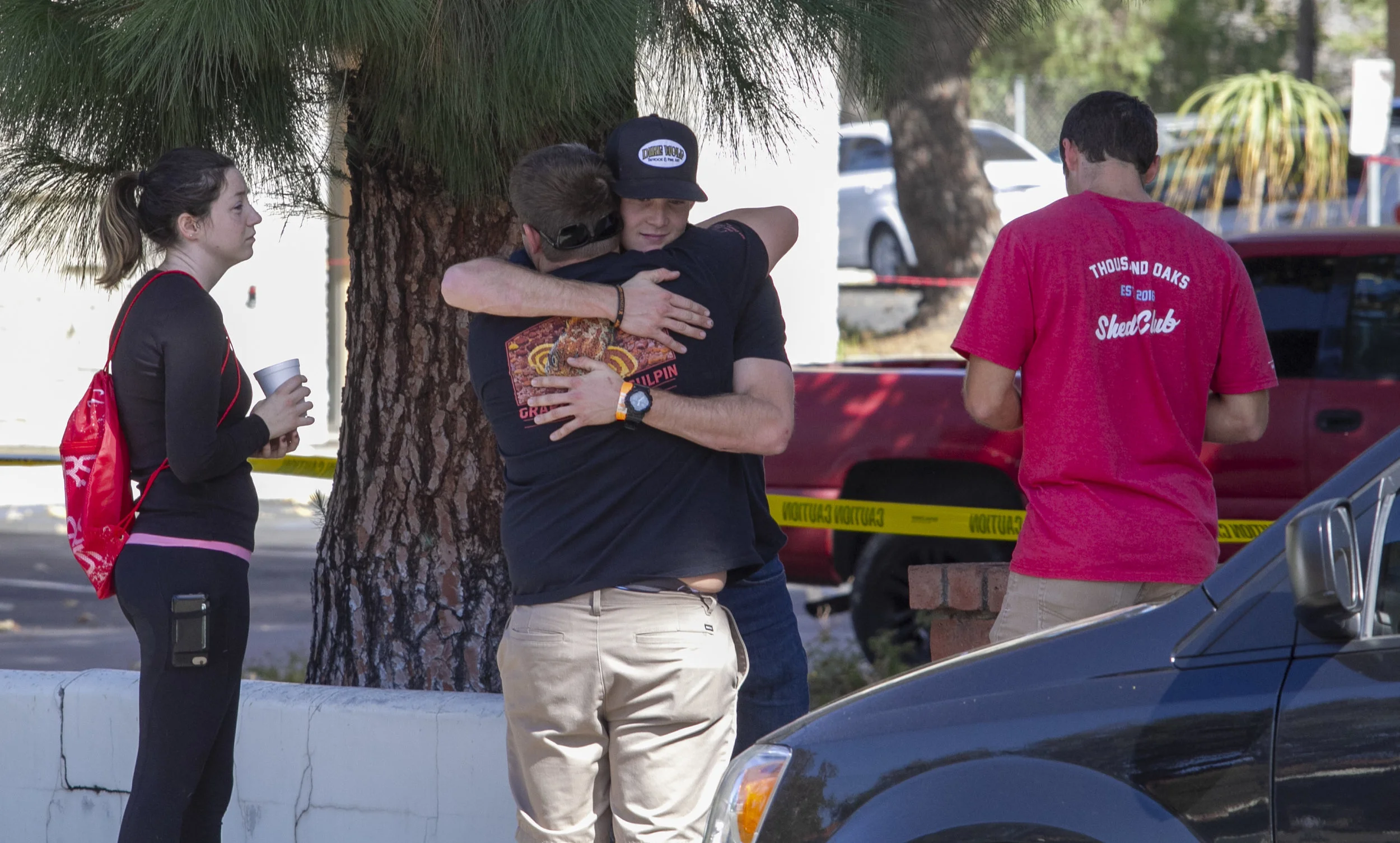 People comfort each other while waiting to speak to authorities. Ian David Long, 28, killed at least 13 and injured more than a dozen at Borderline Bar & Grill in Thousand Oaks, CA on Wednesday, Nov. 7 2018. (Andrew Navarro/ Corsair Staff)