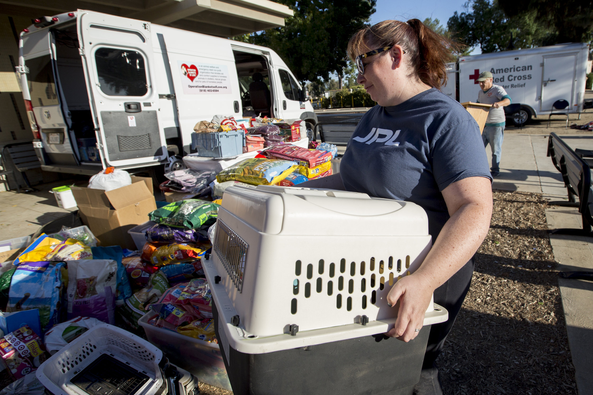 Volunteers, with Operation Blankets of Love, unload pet supplies getting ready to receive evacuated and rescued animals at the Woolsey fire evacuation center set up at Los Angeles Pierce College on November 9, 2018 in Woodland Hills, Calif. (Jose Lopez)