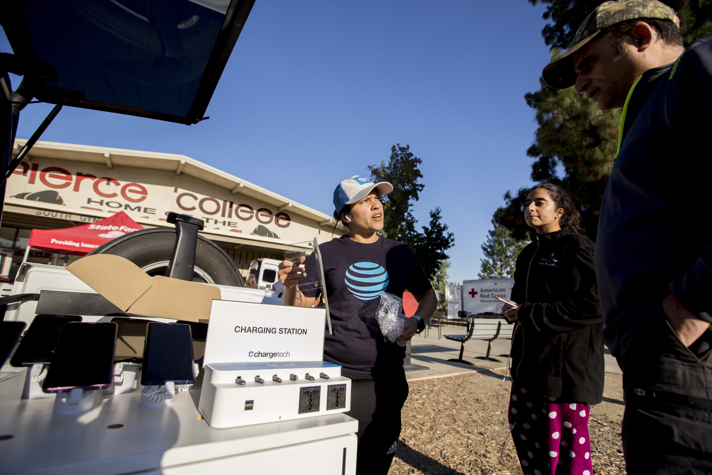  Crystal Segura, with ATT, speaks with evacuees inviting them to charge their phones at the charging station that she is setting up at the Woolsey fire evacuation center at Los Angeles Pierce College on November 9, 2018 in Woodland Hills, Calif. (Jos