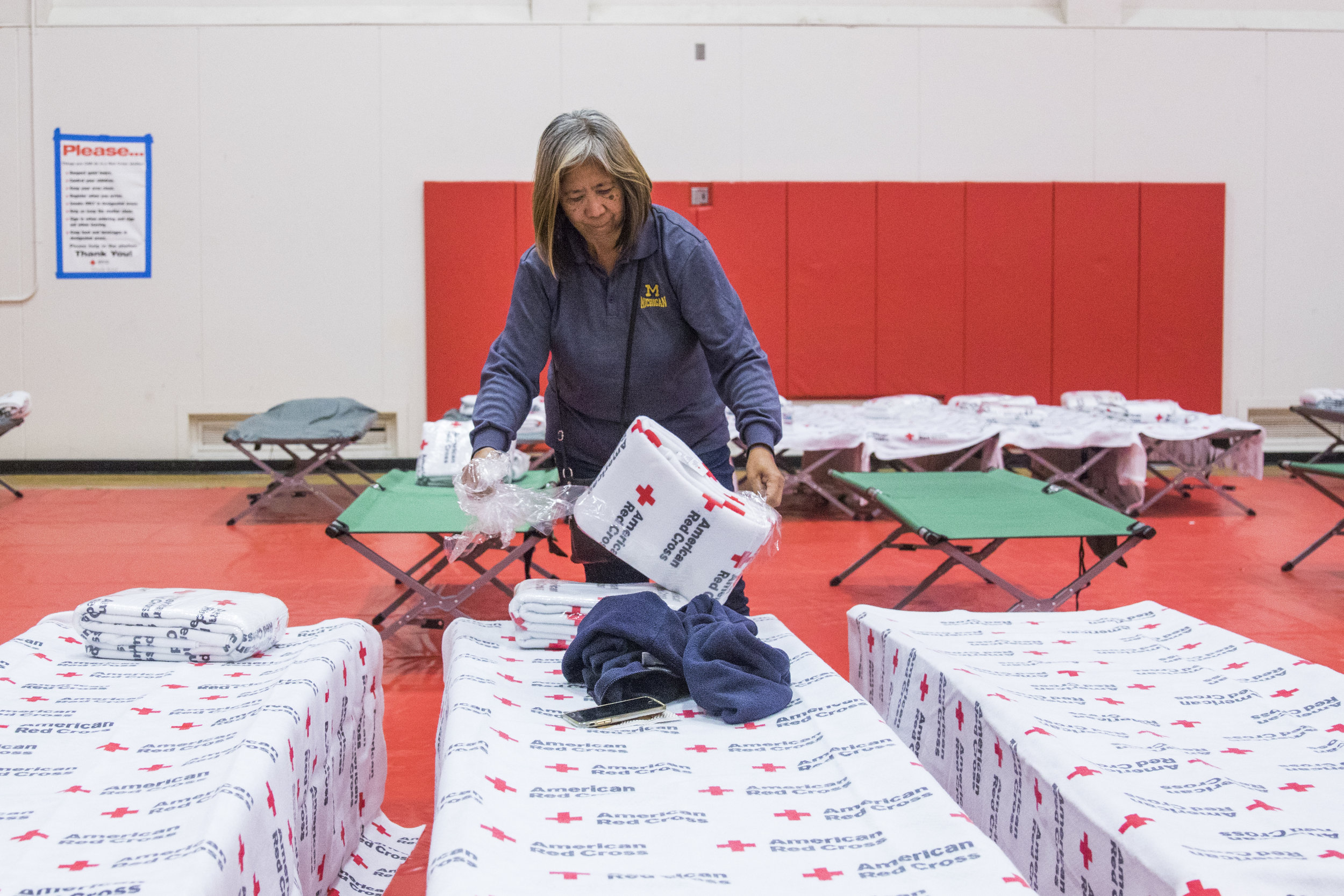  Irene Geske sets up cots for her family inside of Pierce Colleges North Gym in Woodland Hills, California on November 9, 2018. Irene and her family evacuated their home in Oak Park, California two nights ago, but spent last night at a hotel in Van N