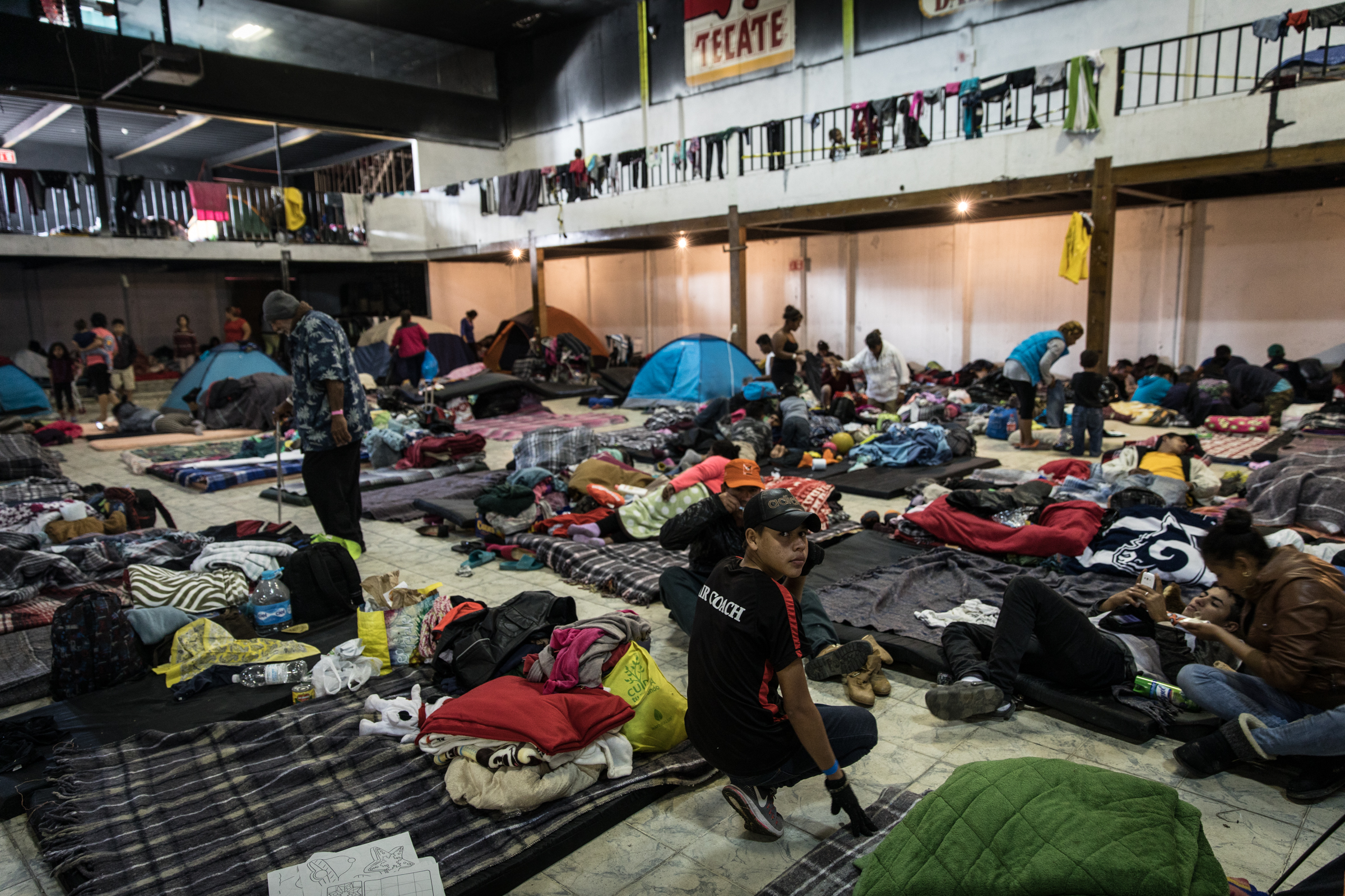   Refugees rebuild their tents and settle in at El Barretal in Tijuana, Mexico, Saturday, Dec. 1, 2018. Asylum seekers previously housed at Benito Juarez sports complex have been moved on Friday, Nov. 30, 2018, due to flooding from rainfall. The new 