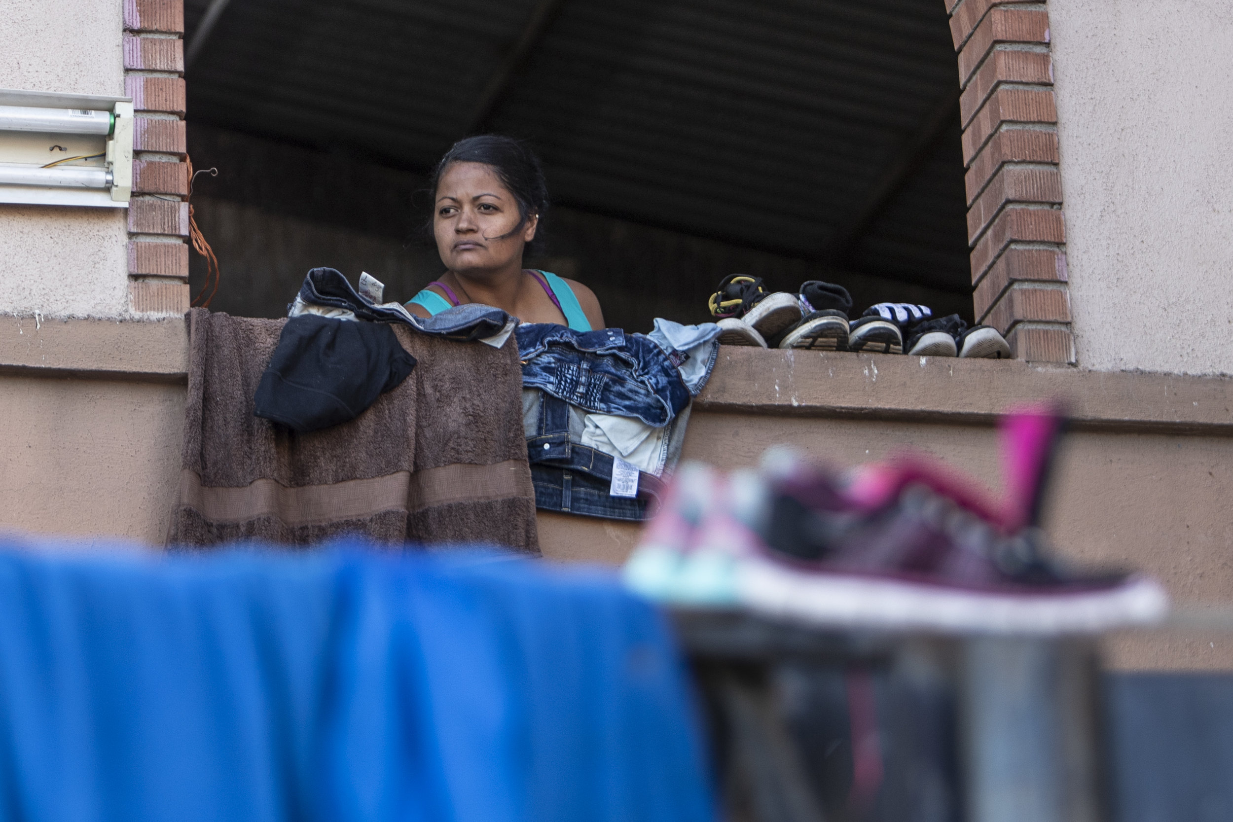   A woman part of the Central American migrant caravan takes shelter in the family ward of the El Barretal nightclub, turned into a temporary shelter  in Tijuana, Mexico, Saturday, Dec. 1, 2018. Photo By: Daniel Bowyer / Corsair Contributor  