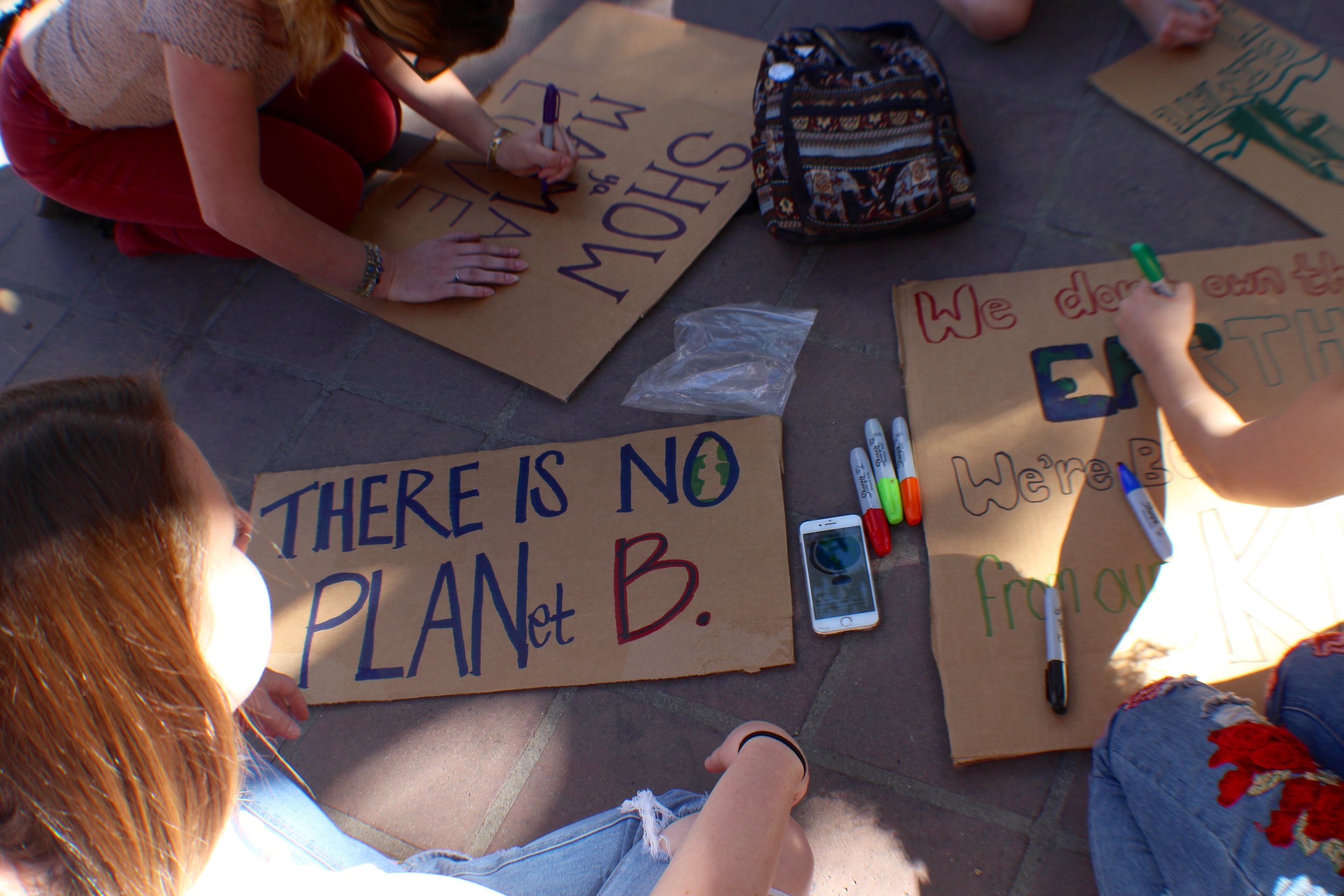  Youth sit together to create signs for the March 15 #FridaysforFuture Climate Strike on the steps of downtown Los Angeles' City Hall. Cardboard was provided as well as a compost bin for signs once the strike had come to a close. (Pyper Witt/ Corsair