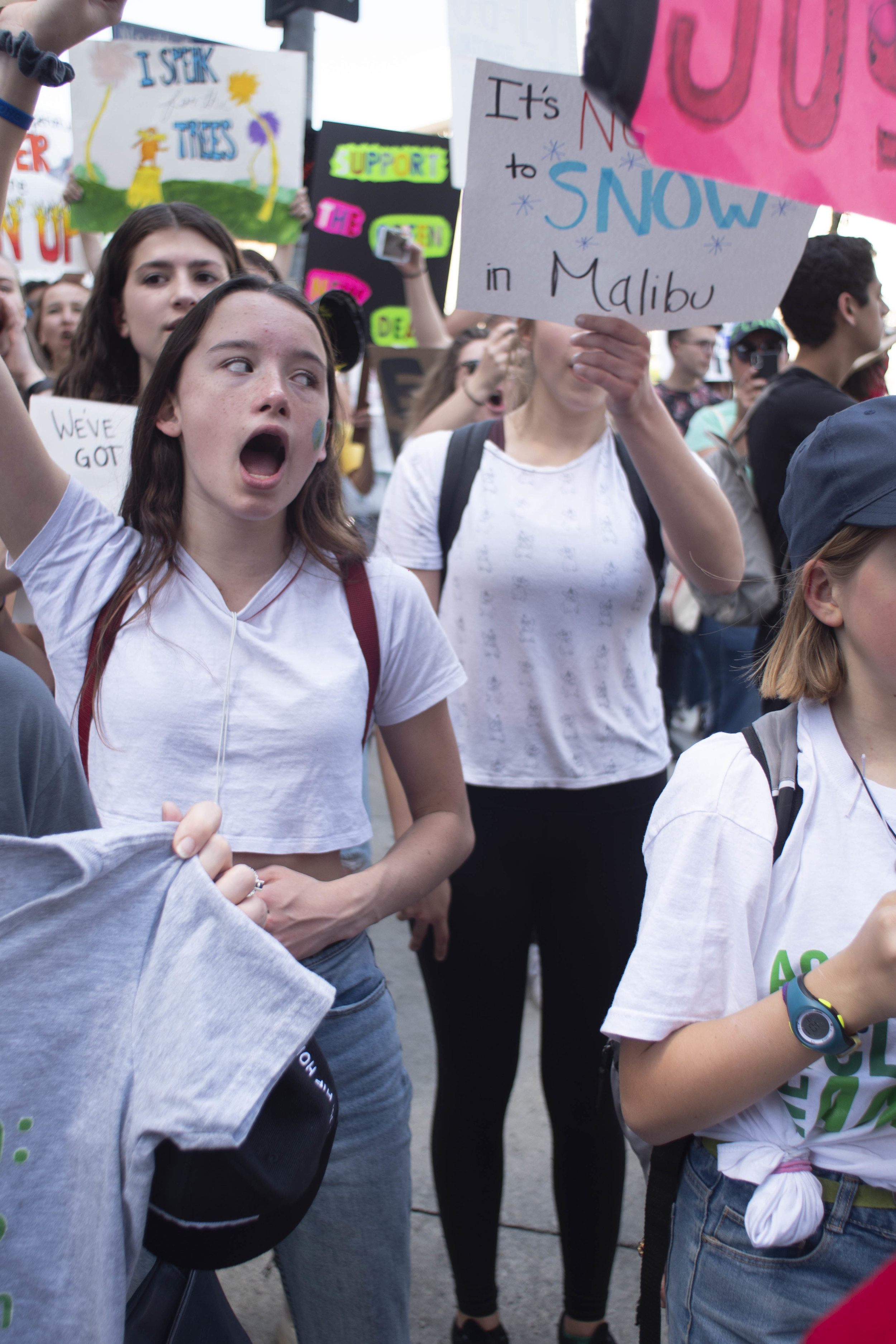 Young activist, sing, cheer, chant, and thrust signs into the air as they call for action while marching around City Hall, in downtown Los Angeles during the International Youth Climate Strike, on Friday March 15, 2019. The movement evolved from a #