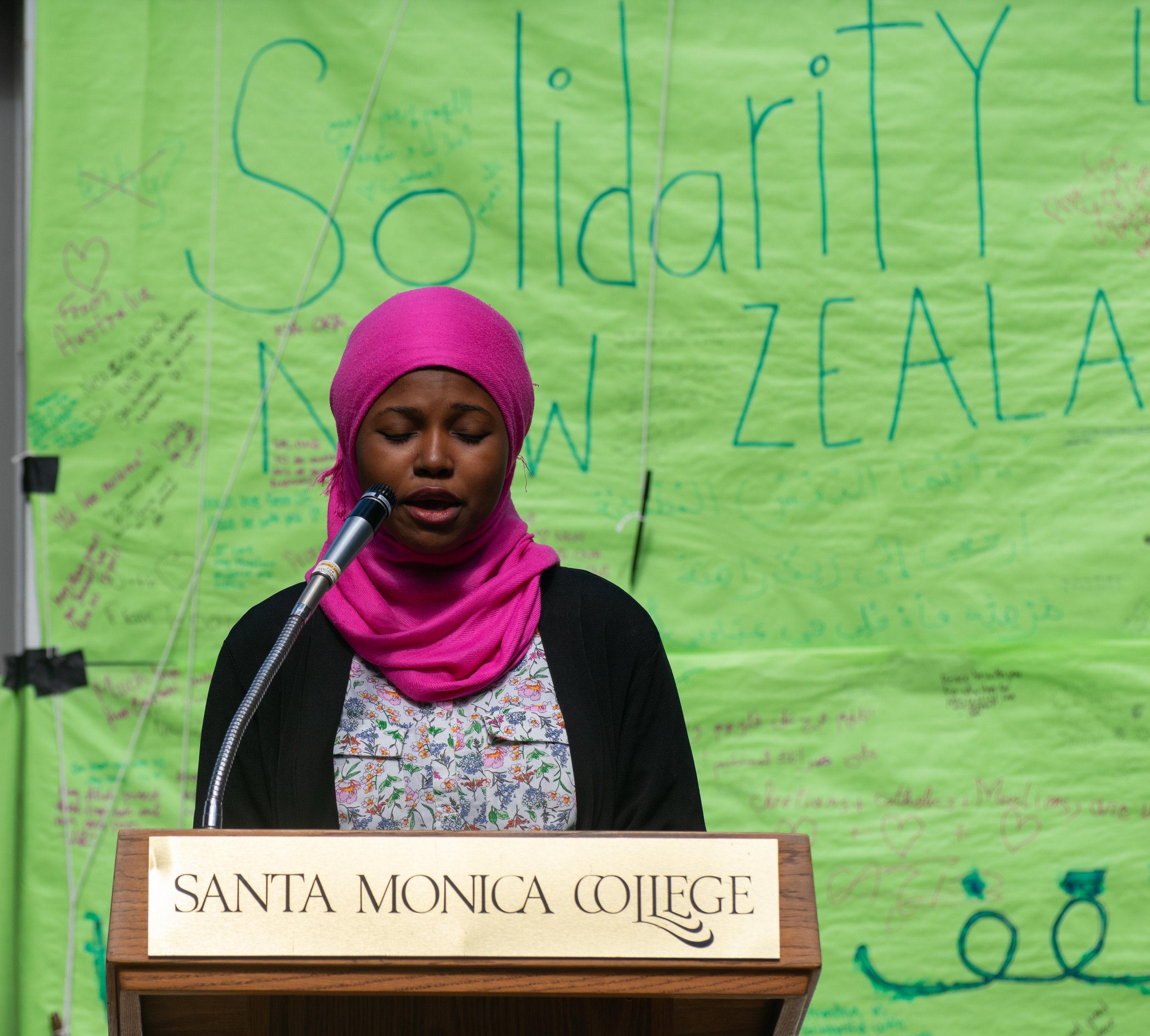  SMC Student Sadia Zaqou signs in Arabic in honor of the victims of the Christchurch, New Zealand shootings at a vigil at SMC in Santa Monica Calif. on Wednesday March 20th 2019. (Photo by Conner Savage Corsair Staff) 