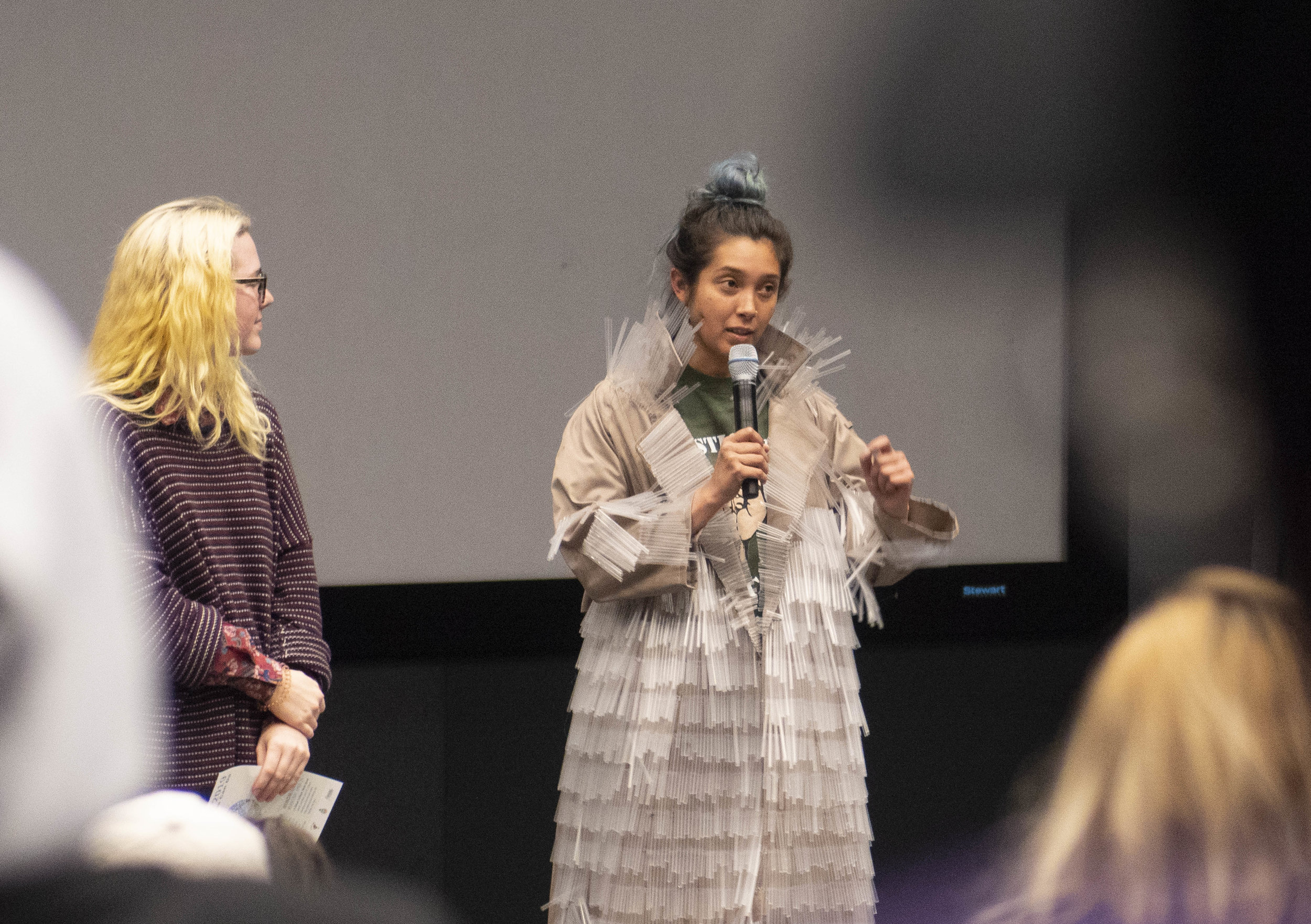  Brooke Harrington (left), watches Carla Claure, who wears a straw infused jacket while answering a question about climate change at a talk before the short film “Straws,” on Thursday April 4. She and other Santa Monica College (SMC) Sustainability C