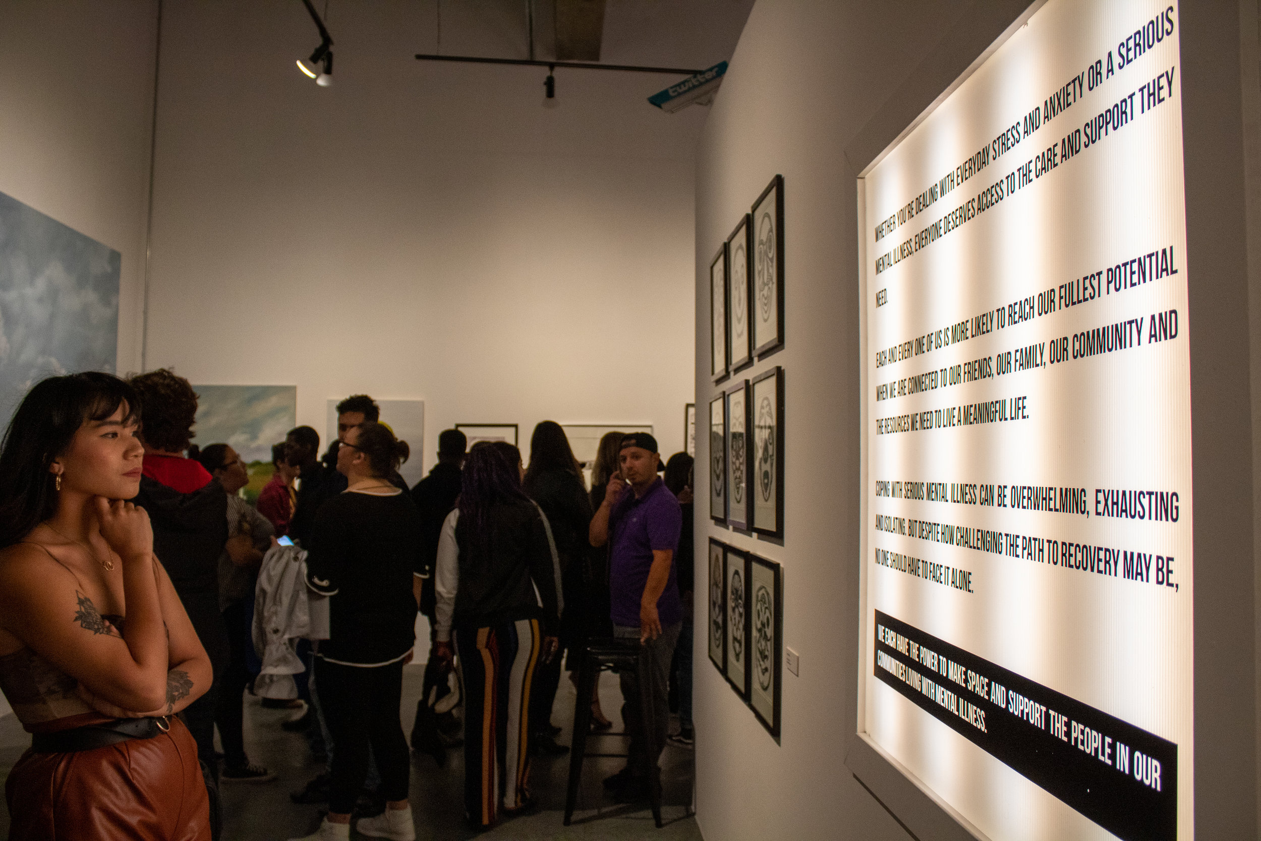 Attendees observe the exhibitions that fill the gallery space of We Rise LA on May 17, 2019. We Rise is a pop-up immersive art gallery and community space in Los Angeles, California, focused on themes of Connectedness and Purpose, aiming to engage w