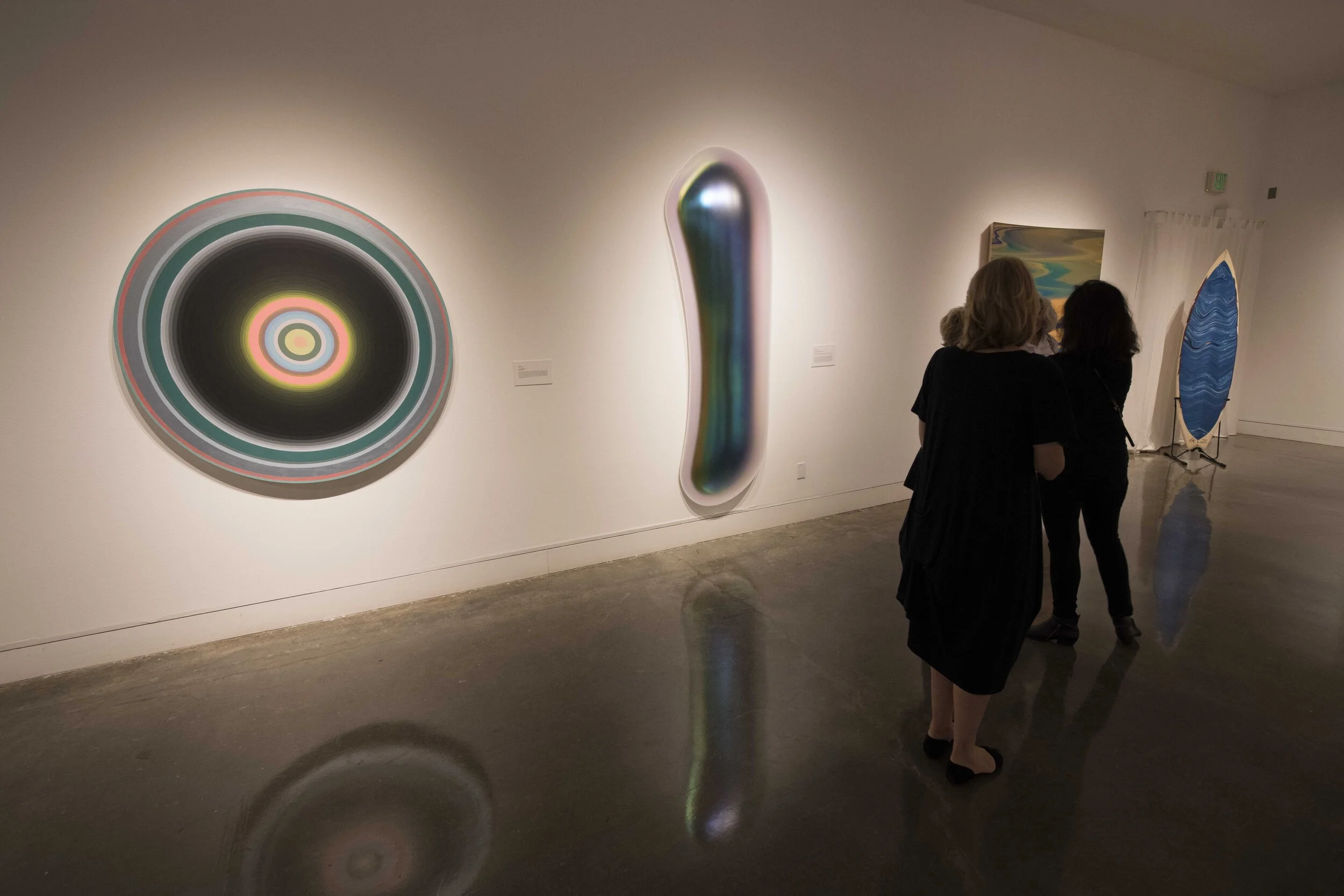 Visitors admiring the gallery art, one of which is Gisela Colon’s “Oval Melt Glo-Pod.” Los Angeles, Calif. (Kevin Tidmore/The Corsair)