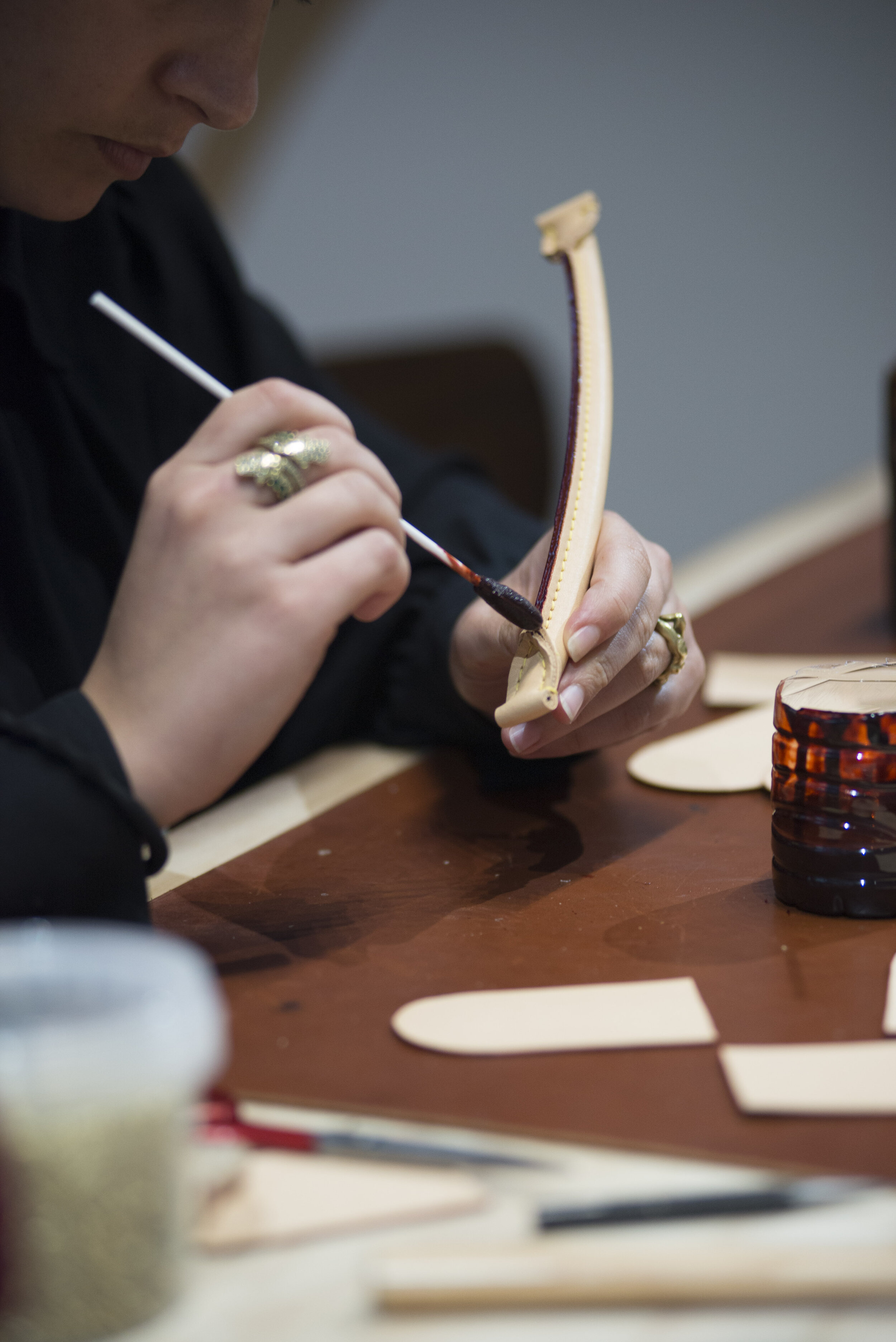  Artisan shows audience the process in making one of Louis Vuitton’s bags.  (Anthony Mayen/The Corsair)  