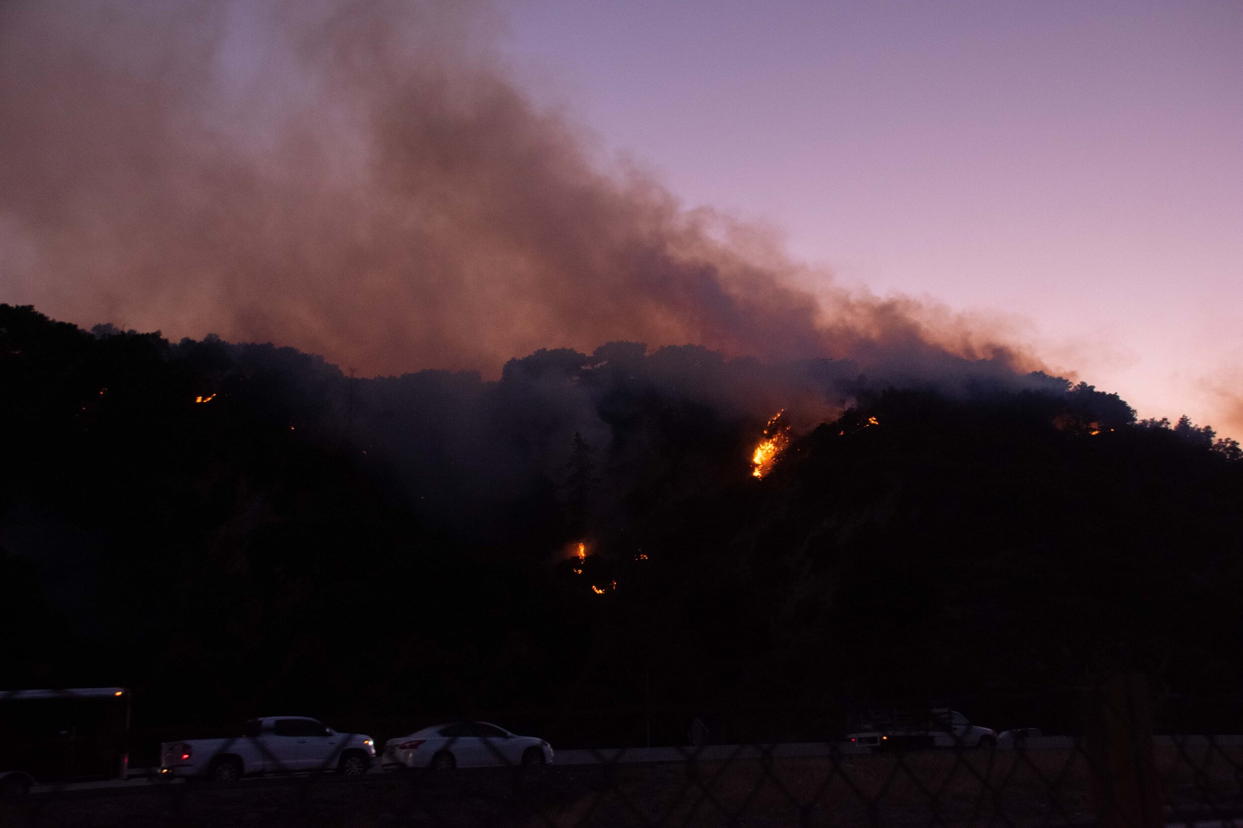  Cars on interstate highway 5 passing a portion of the Saddlerige Fire as the sun sets near Newhall Calif. on Friday, Oct. 11, 2019. (Conner Savage/The Corsair) 