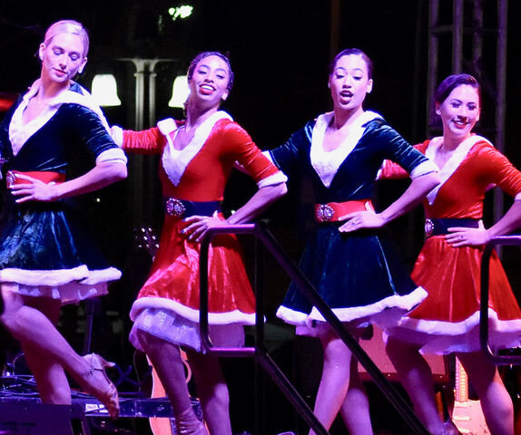  Cultural-diverse women wear their Christmasy dress costume while giving a dance performance at the stage. (Dennisa Villa / The Corsair) 