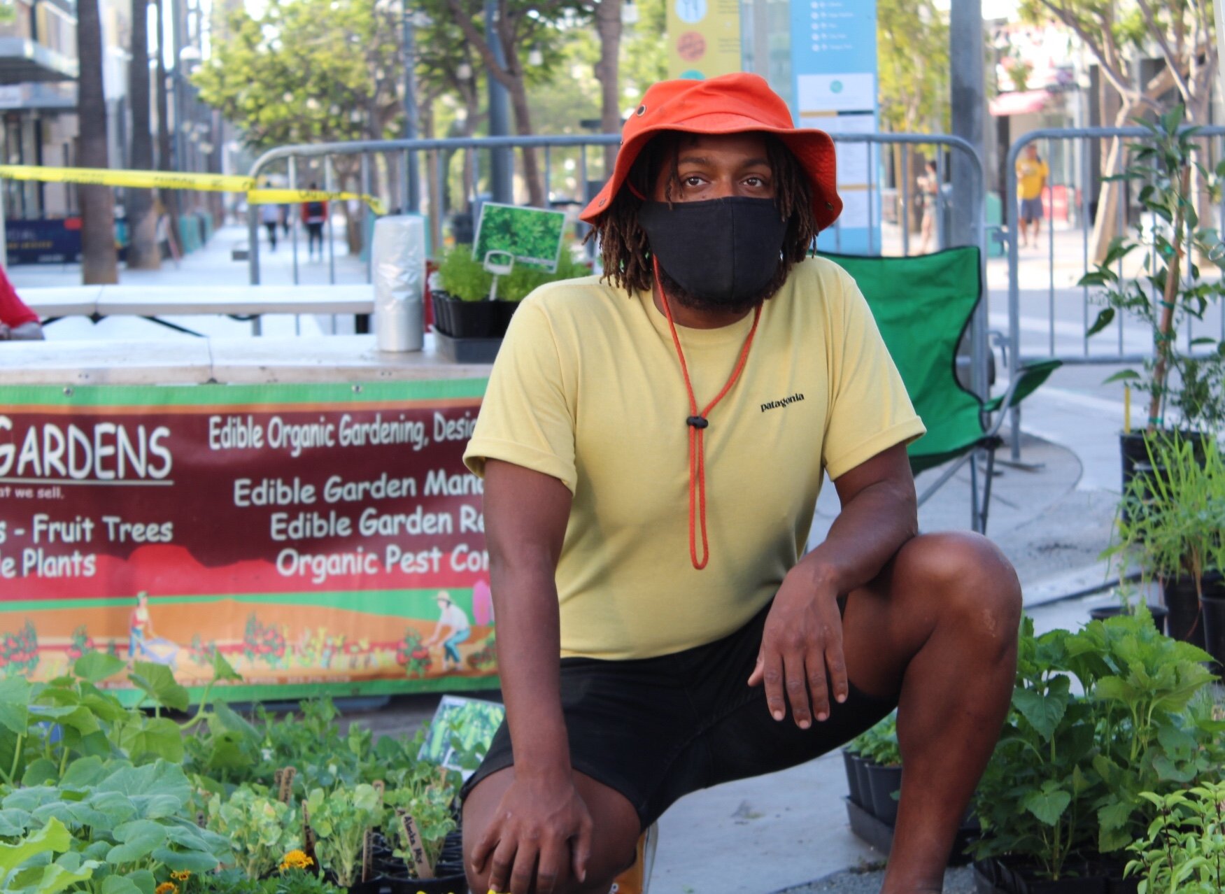  A Logan’s Gardens farmer at the Santa Monica Farmers Market on Saturday, September 5, 2020 in Santa Monica, Calif. He takes a knee proudly displaying his array of edible plants. Logan’s Gardens, located in Silverlake, is believed to be the only Bla