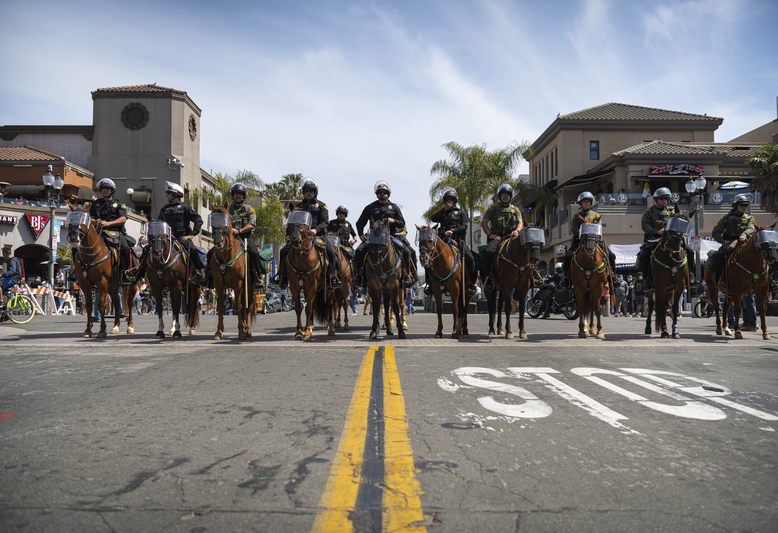  Huntington Beach Police officers assemble to dispurse the angry crowds at the Black Lives Matter/ White Lives Matter protest held in Huntington Beach Calif. on March 11, 2021. (Jon Putman / The Corsair) 