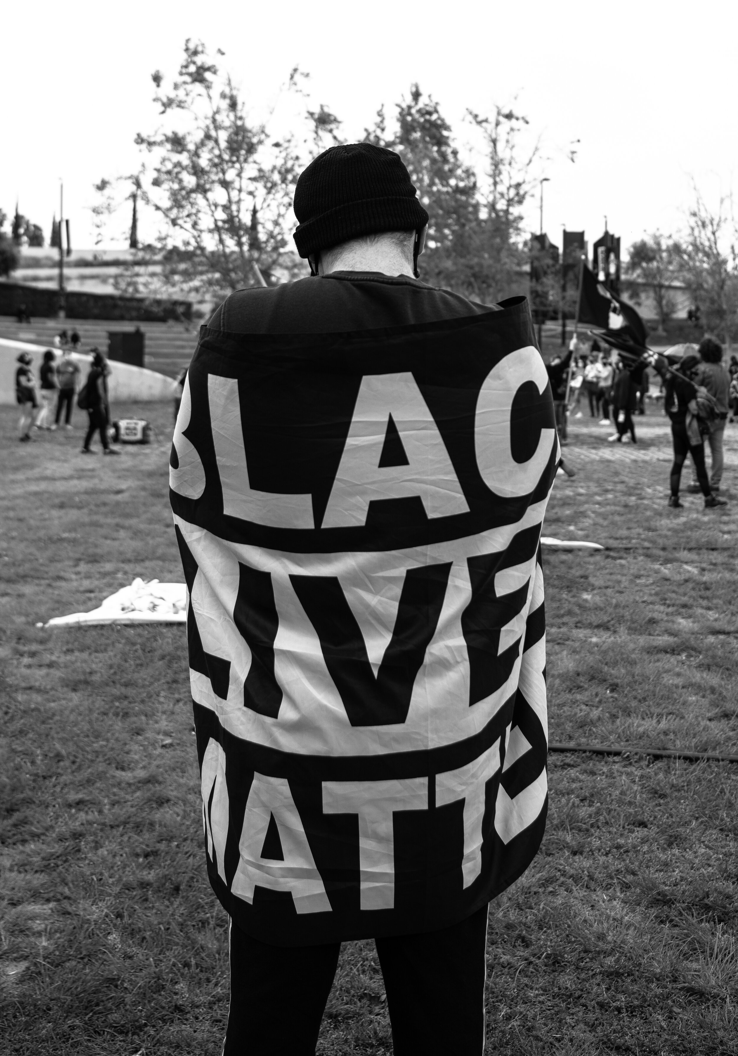  A Black Lives Matter supporter stands proudly with a Black Lives Matter flag draped acrossed his back at the event memorial held for George Floyd on April 25, 2021 in Hollywood Calif. (Jon Putman / The Corsair) 