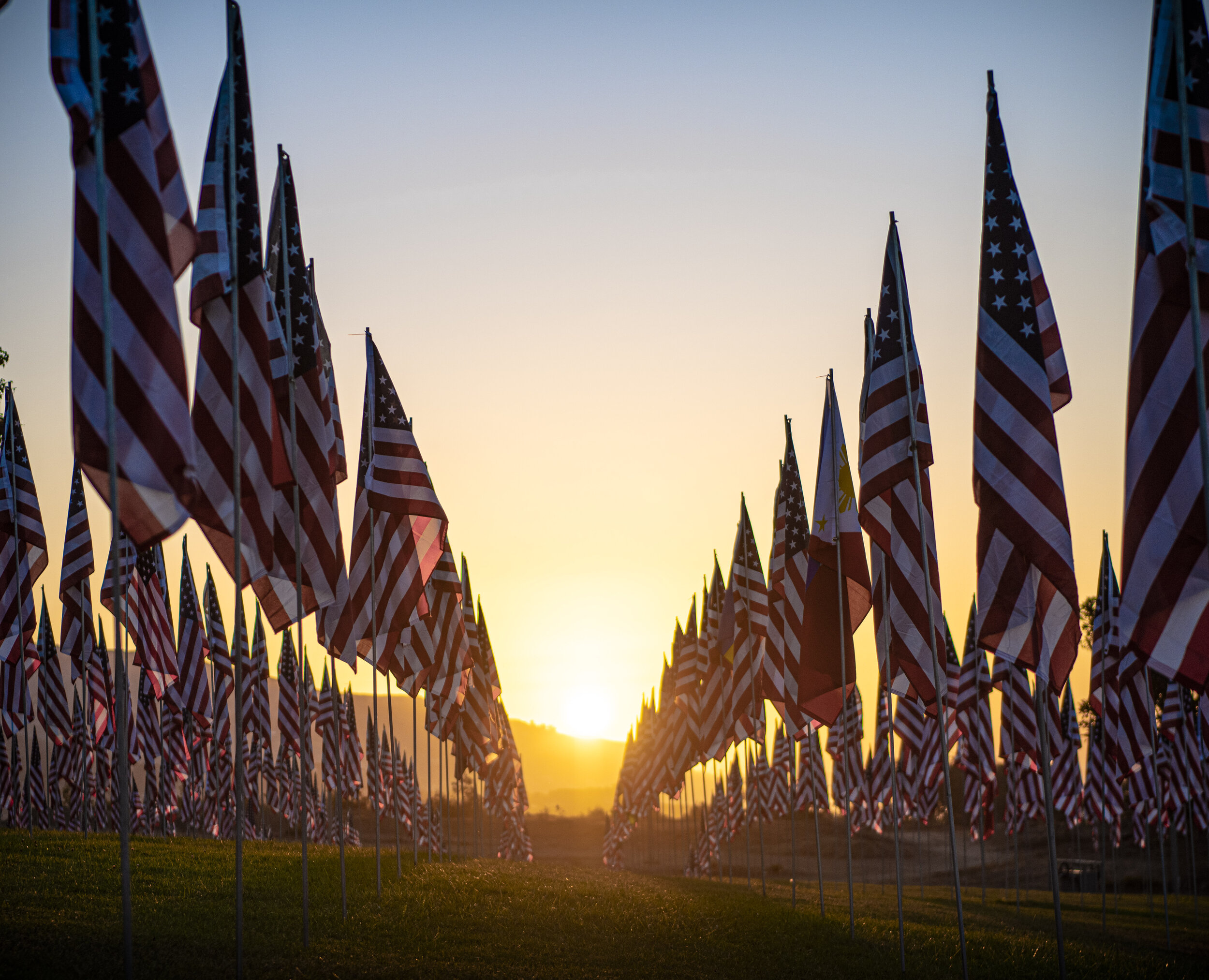  The sun rises among the Waves of Flags memorial for the 20th anniversary for the 9/11 attacks located at Pepperdine University in Malibu Calif on September 11, 2021. (Jon Putman | The Corsair) 