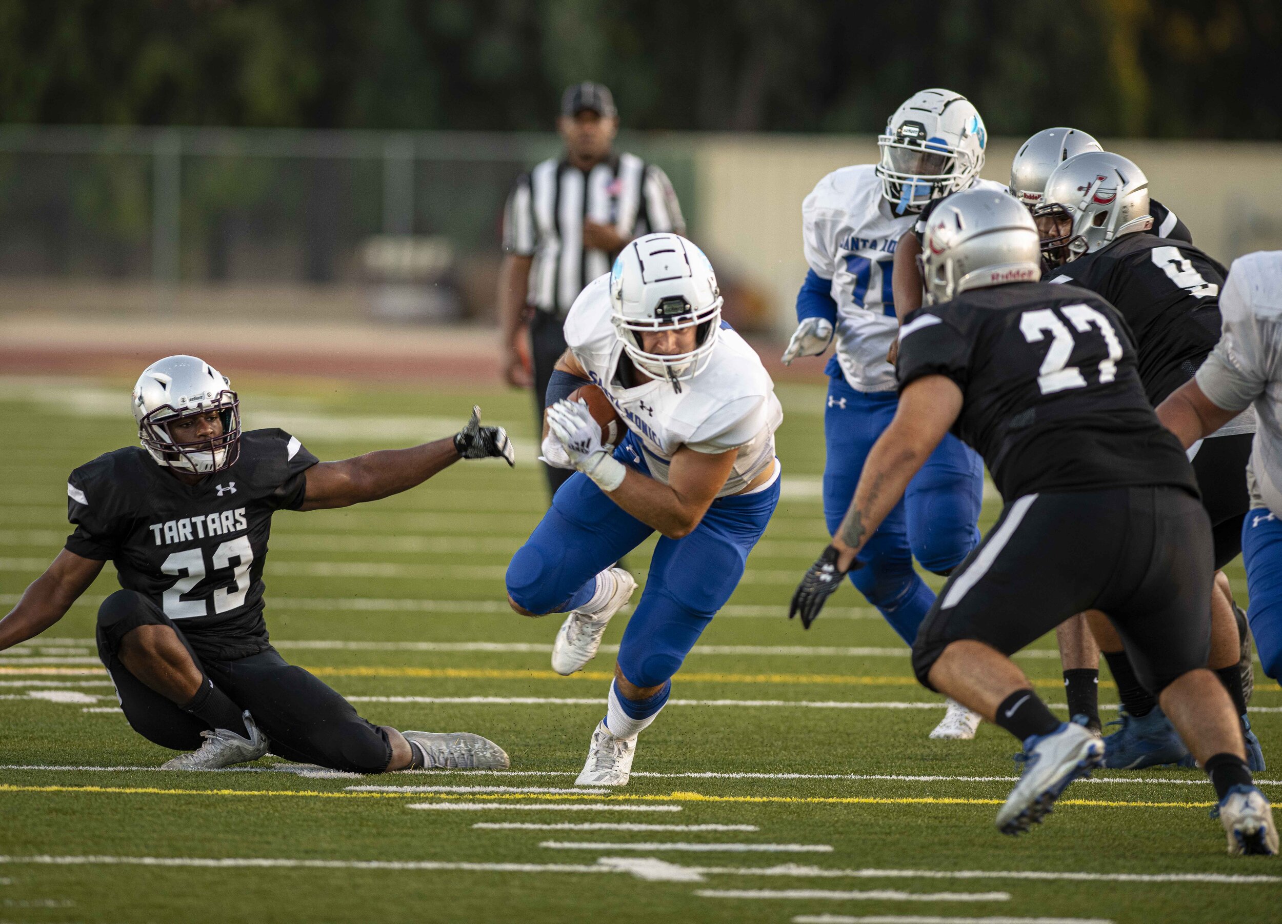  Santa Monica College running-back Olek Hicks (2), eludes defenders as he fights for the first down marker on September 11, 2021, at Compton College in Compton, Calif. (Jon Putman | The Corsair) 