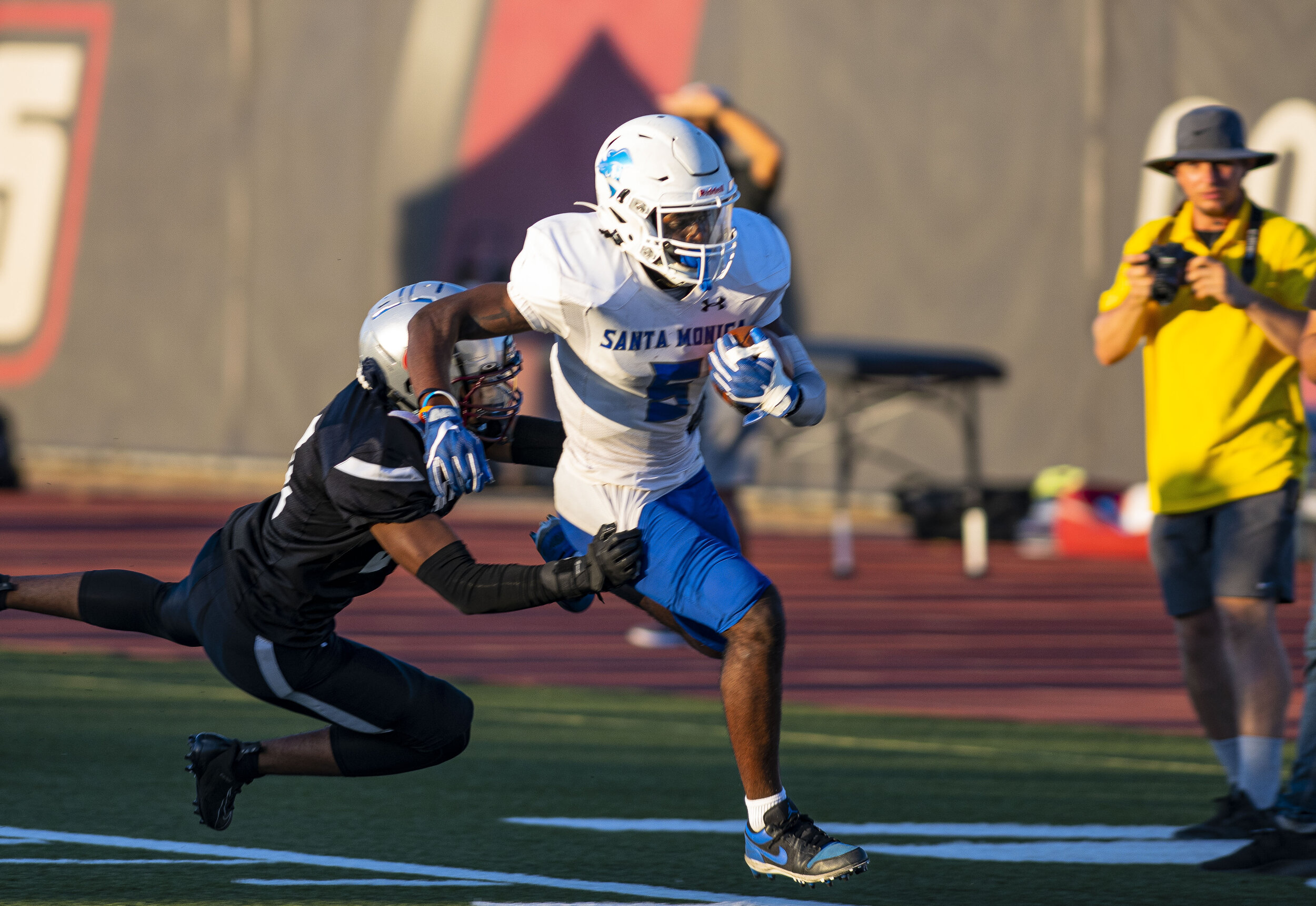  Santa Monica College wide-wide-reciever Tariq Brown (5), tries to outrun leaping defenders on September 11, 2021 at Compton College in Compton Calif. (Jon Putman | The Corsair) 