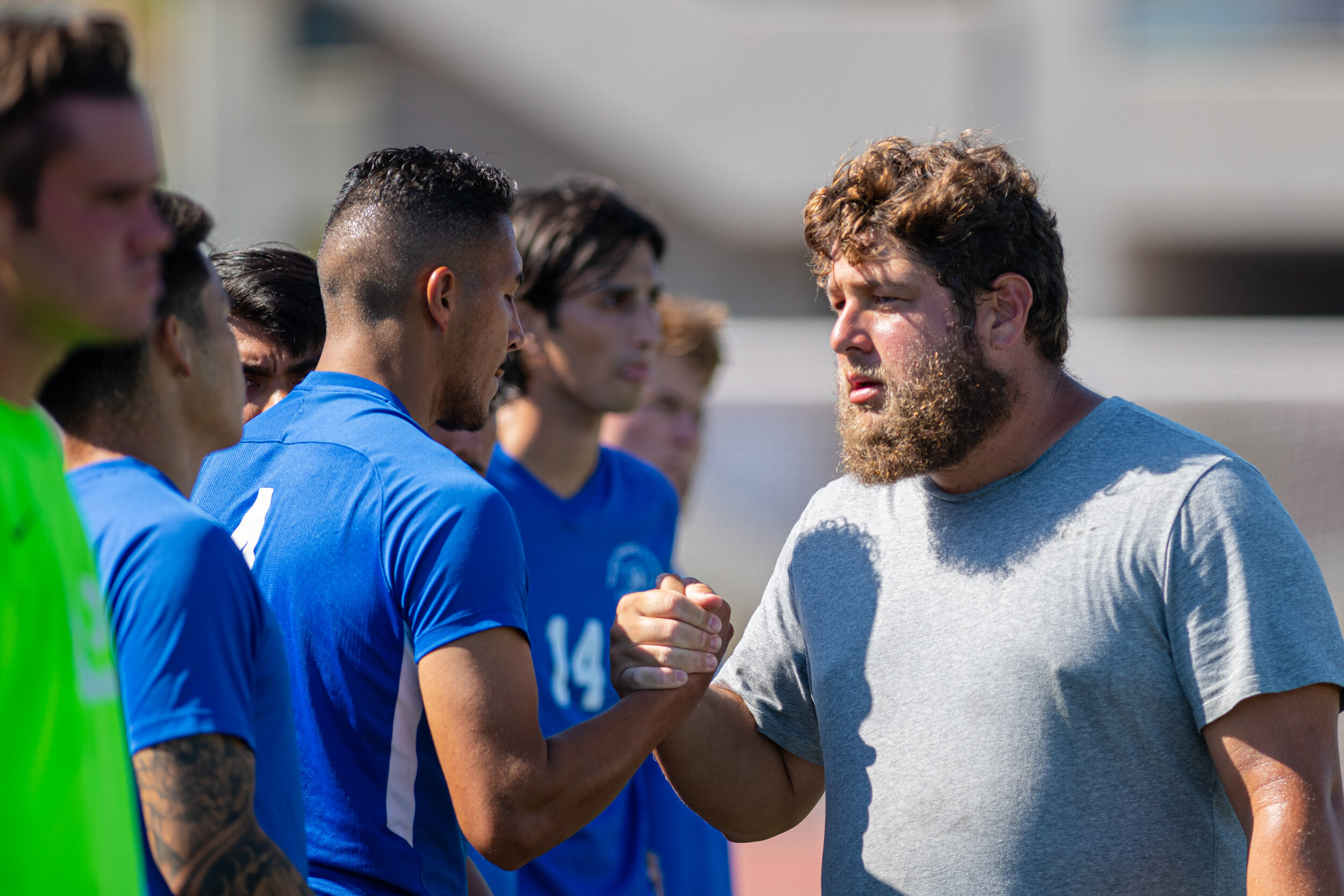  SMC Mens Soccer Head Coach Tim Pierce (Right), shakes hands with his players before they take the field on September 23, 2021, at Santa Monica College in Santa Monica, Calif. (Jon Putman | The Corsair) 
