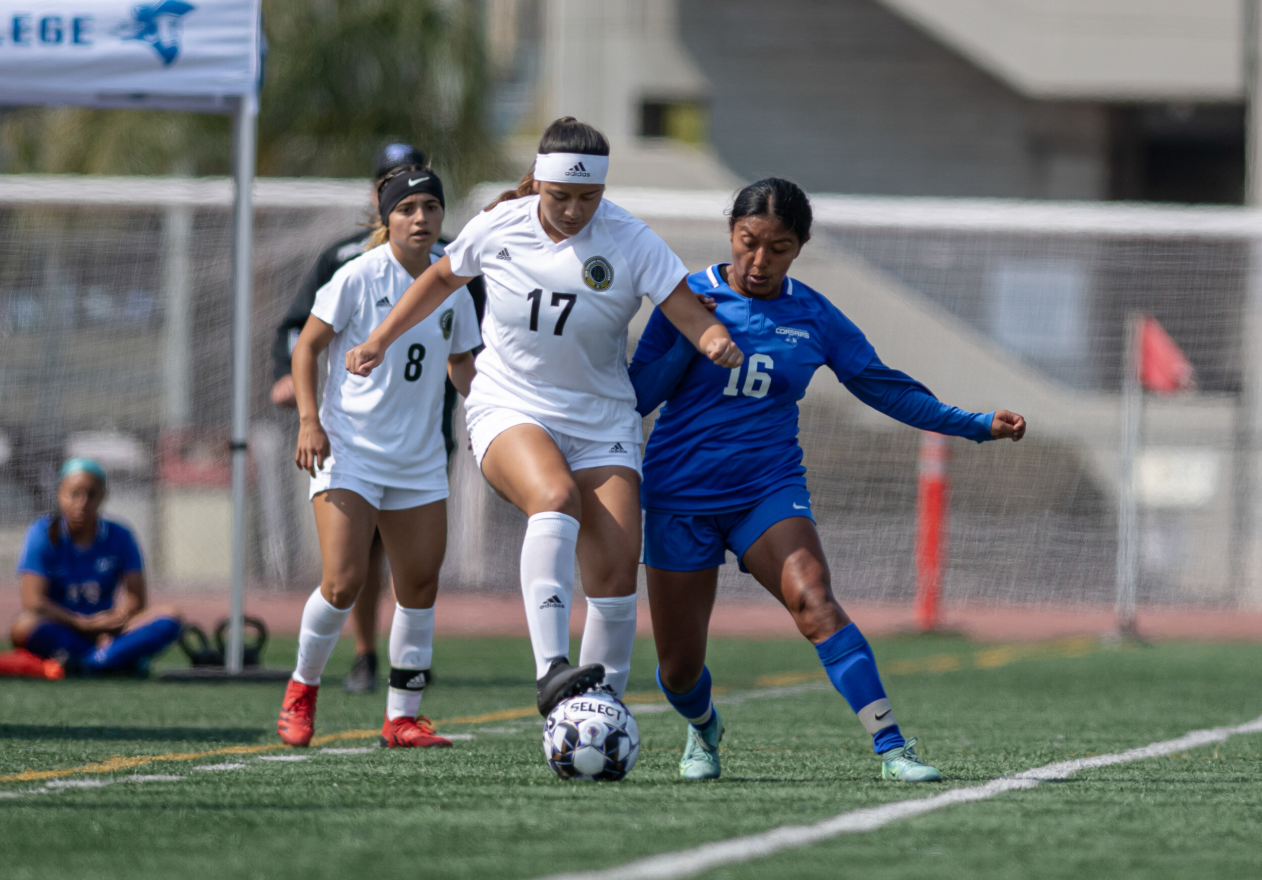  SMC freshman Diana Gaspar (16) goes head to head with a defender as she tries to take the ball from the opposing player. (Jon Putman | The Corsair) 