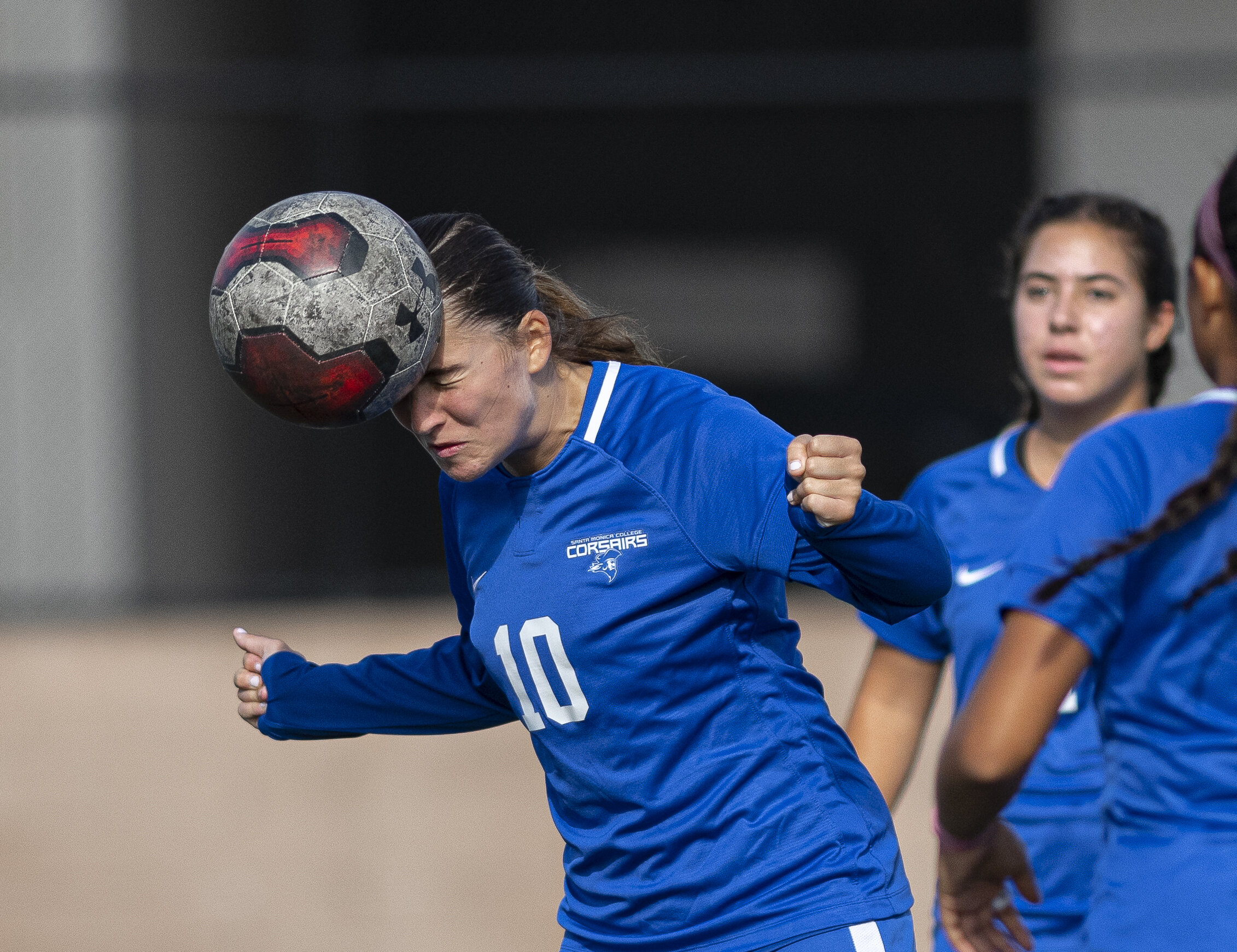  Santa Monica College Corsairs Woman's soccer player heads the ball into the goal during warmups just before the game begins with Citrus College. (Jon Putman | The Corsair) 