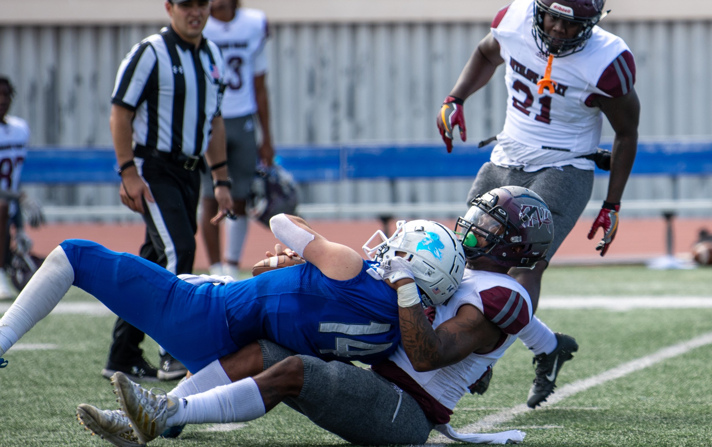  QB Sam Vaulton (14) finds himself sacked and turned around at Santa Monica College's main campus field in Santa Monica, Calif. on October 23, 2021. The game against Antelope Valley is the first home game since a nine-person COVID infection that forc
