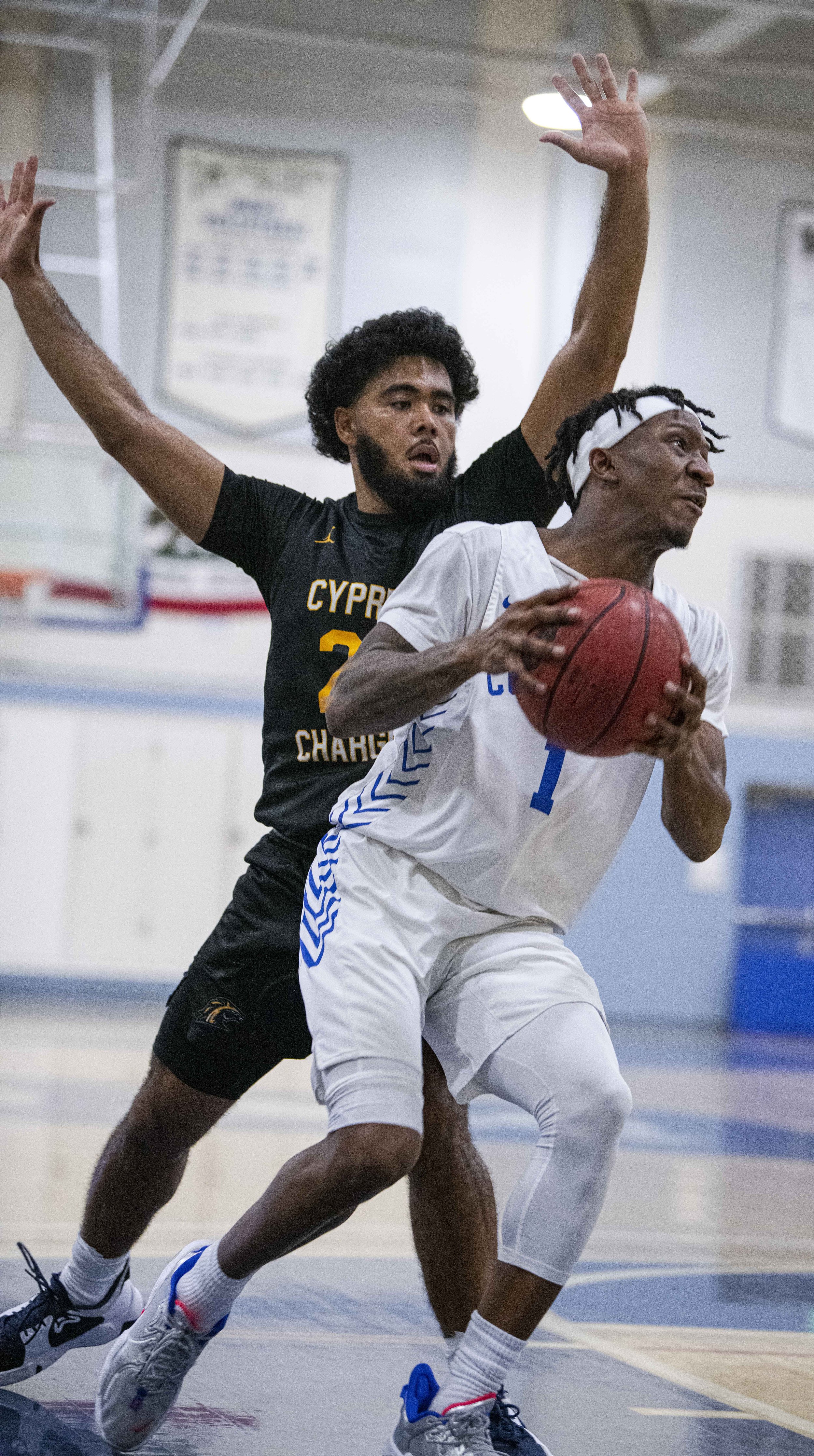  Santa Monica College Corsairs sophomore Jarrell Williams (1) dribbles the ball past a Cypress defender as he drives to the hoop. (Jon Putman | The Corsair) 