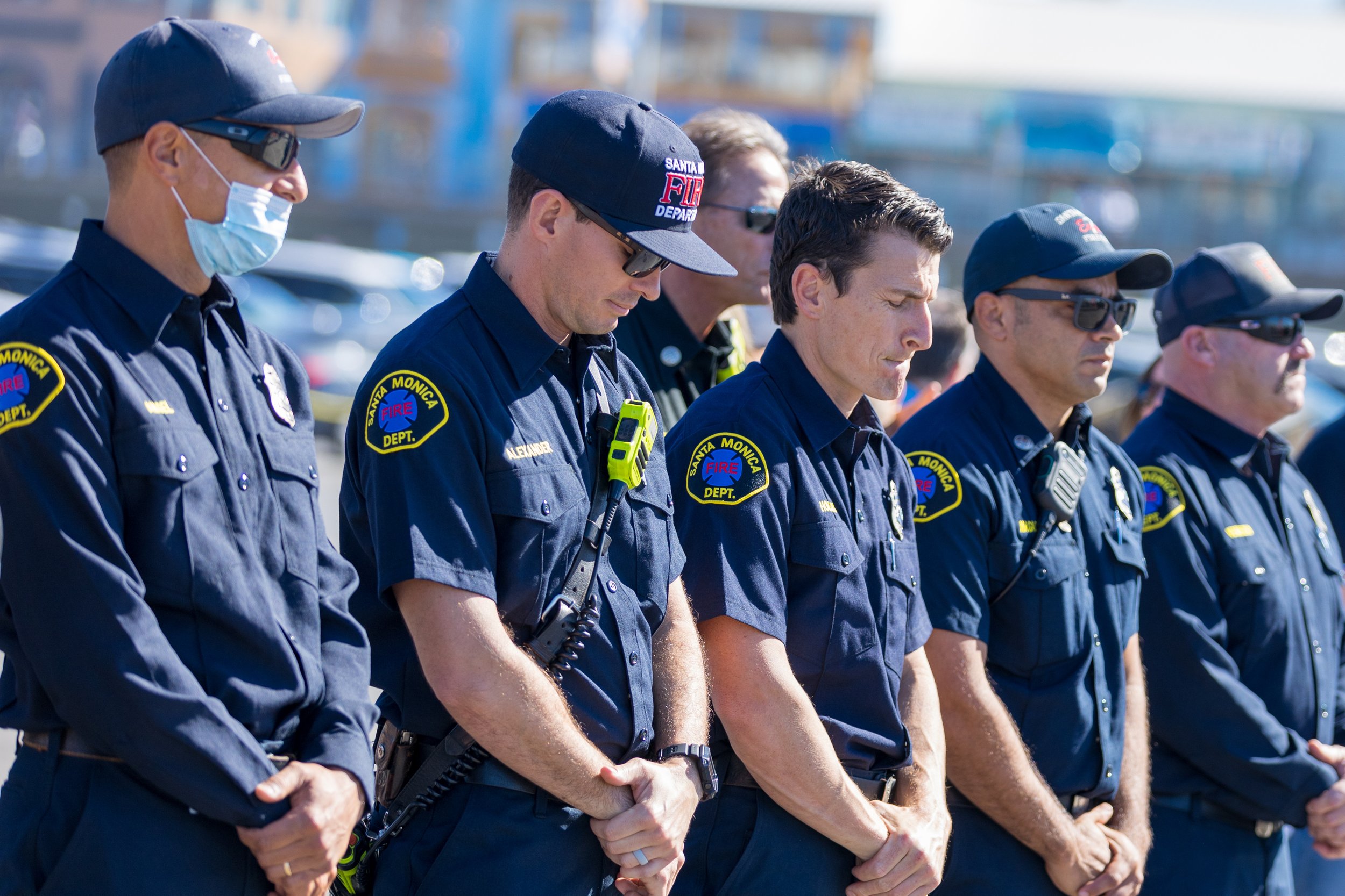  Members of the Santa Monica fire department take a moment of silence at the Veterans Day commemoration near the Santa Monica Pier in Santa Monica, California on November 11, 2021. (Maxim Elramsisy | The Corsair) 