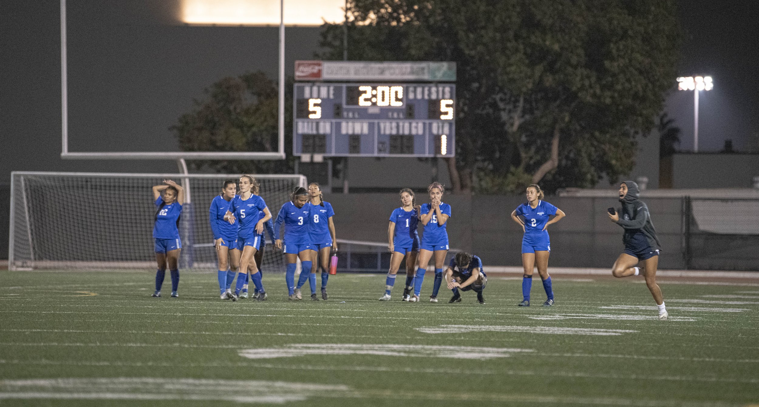  Santa Monica College Corsairs players sit in shock as an El Camino College player runs in frame after the Corsairs goalie missed the final shoot out attempt on Nov. 18, 2021 at Santa Monica College. The Corsairs would take the 5-4 loss to end their 