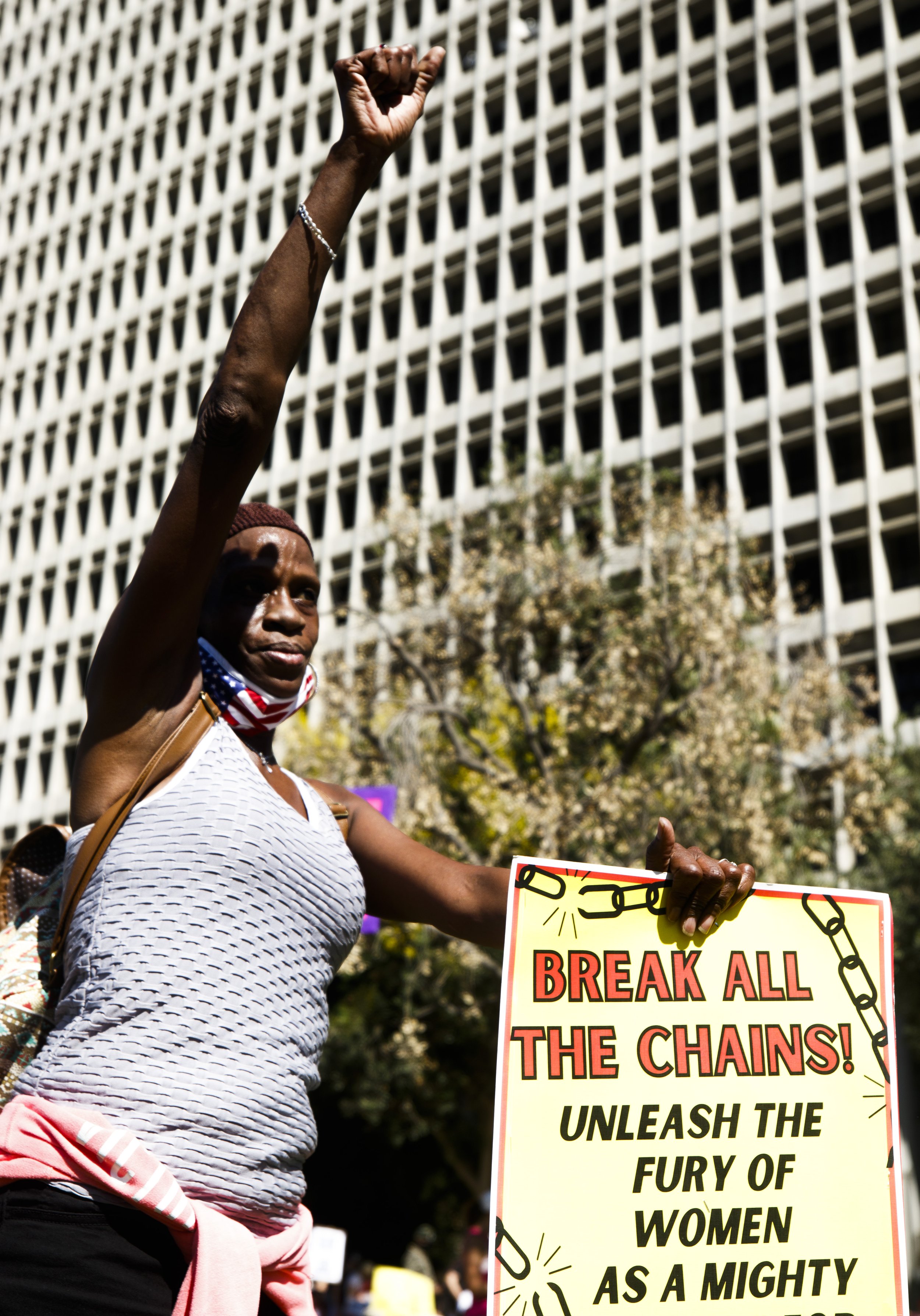  Protestor, healthcare worker, and rape victim Tina Larrimore holds her fist high passionately shouting out in agreeance with a speaker at the march for reproductive rights in grand park down town Los Angeles on October 2, 2021. ( Neil O’Loughlin | C