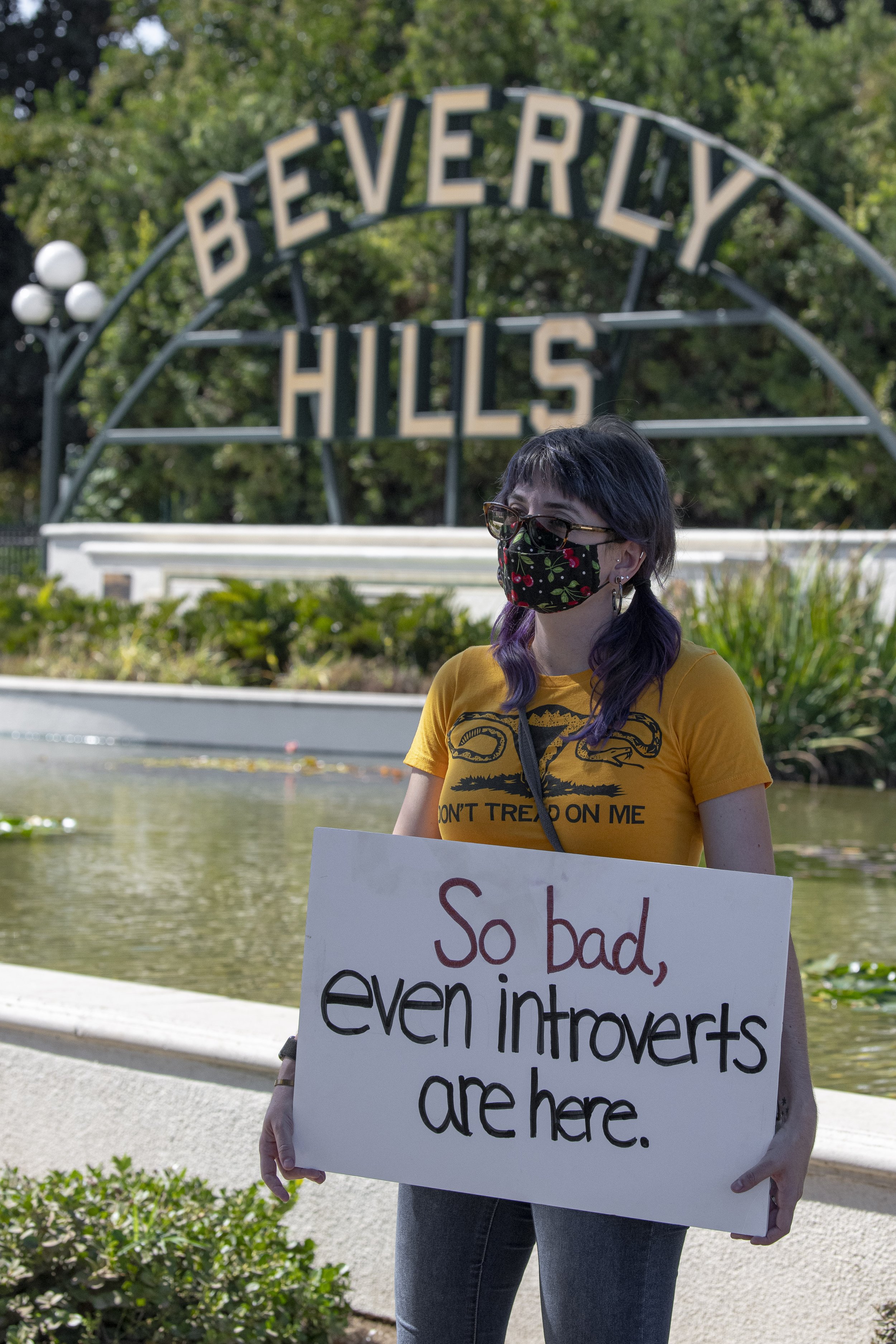  A supporter of the Womens abortion march held at the Beverly Gardens Park located in Beverly Hills, Calif. Sat. Oct. 2,stands with her sign in front of the famous Beverly Hills sign. (Jon Putman | The Corsair) 