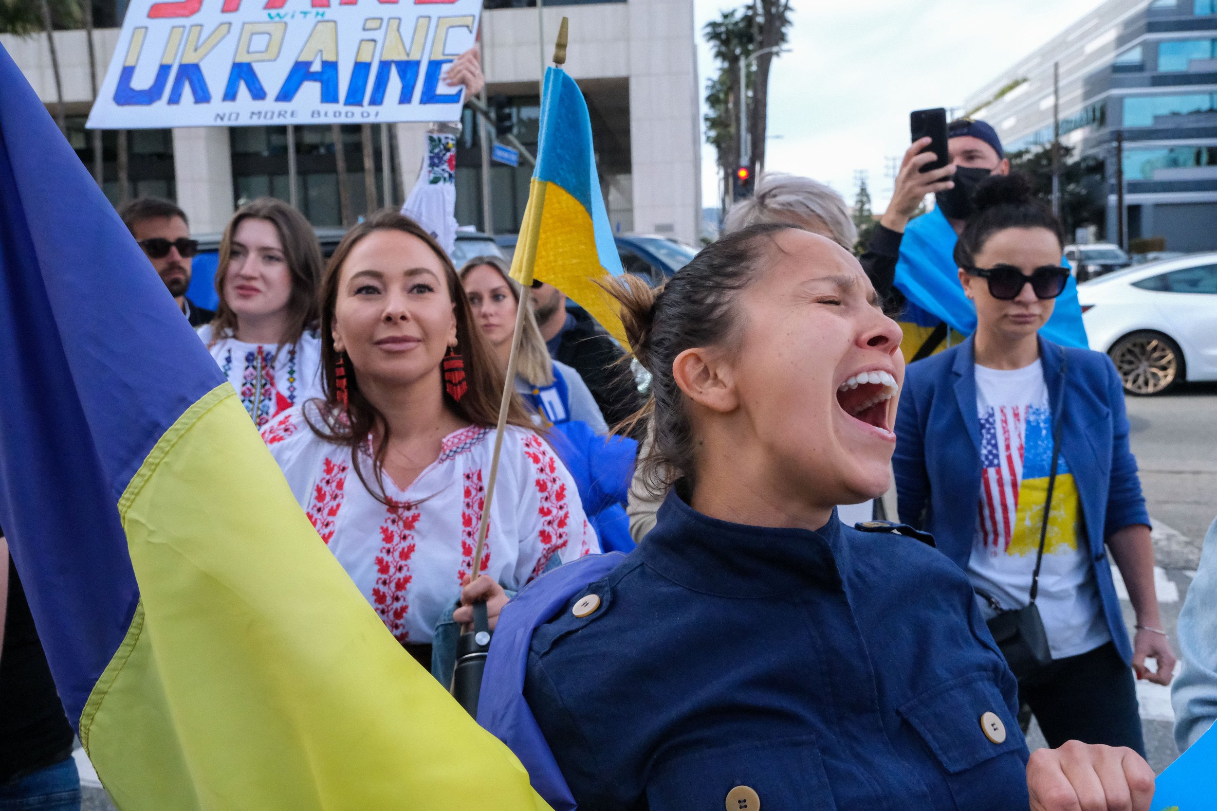  Above, a woman crossing the street yells to lead others surrounding her in a Ukrainian chant at the Rally for Ukraine in Los Angeles, on Saturday, Feb. 26. (Anna Sophia Moltke | The Corsair) 