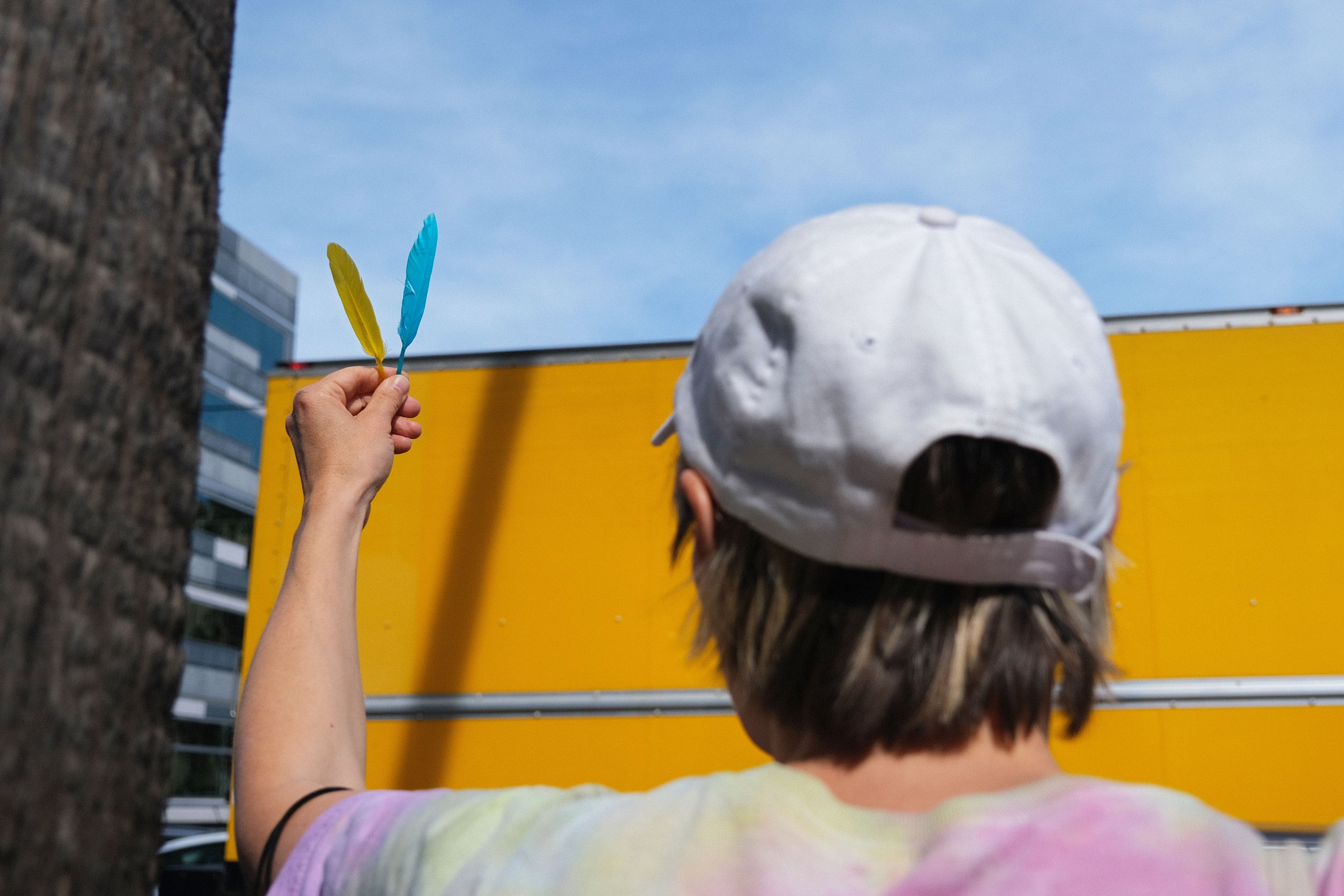  Above, Liisa Jokinen holds up two feathers in Los Angeles on Feb. 26. Visiting Los Angeles from Finland, she found these feathers while looking for blue and yellow things she could use to show her support for Ukraine. She fears that if Russia is suc