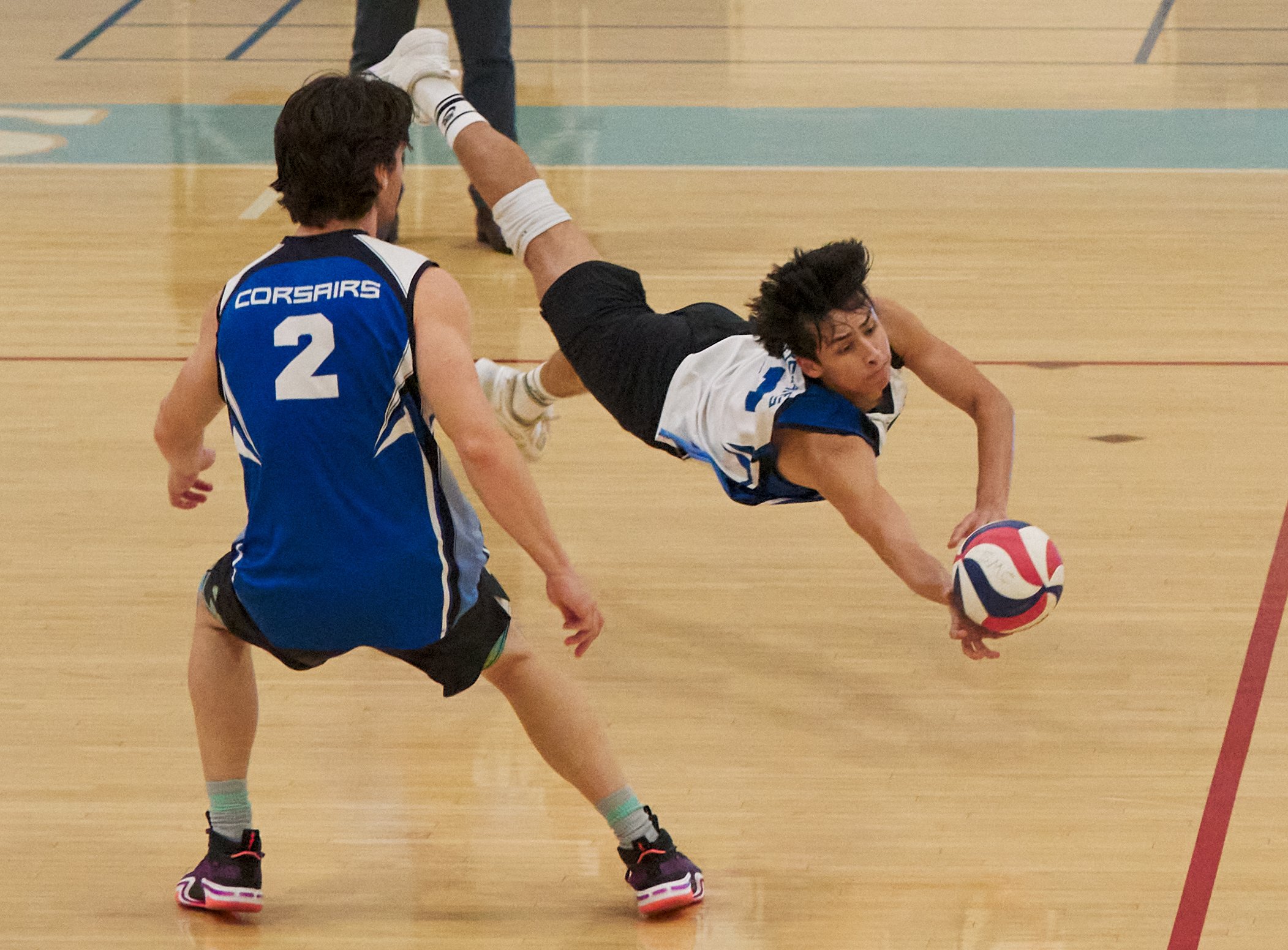  Santa Monica College Corsairs' Javier Castillo dives for the ball during the men's volleyball during the men's volleyball game against the Santa Barbara City College Vaqueros. Freshman Mason Johnson also pictured. SMC won the game 3-2 on Wednesday, 