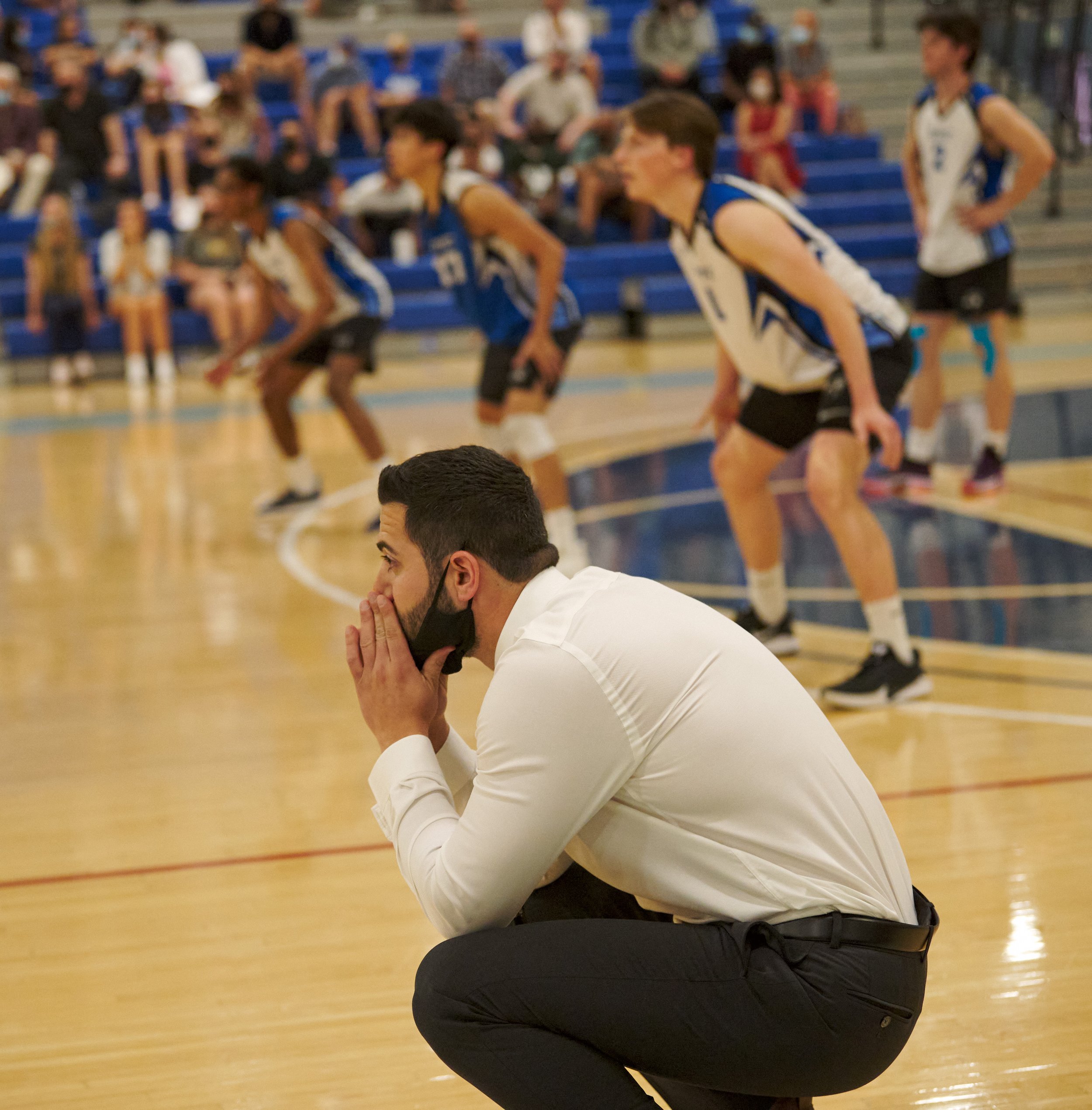  Santa Monica College Corsairs men's volleyball Head Coach Liran Zamir squats near the end of the game against the Long Beach City College Vikings. (Nicholas McCall | The Corsair) 