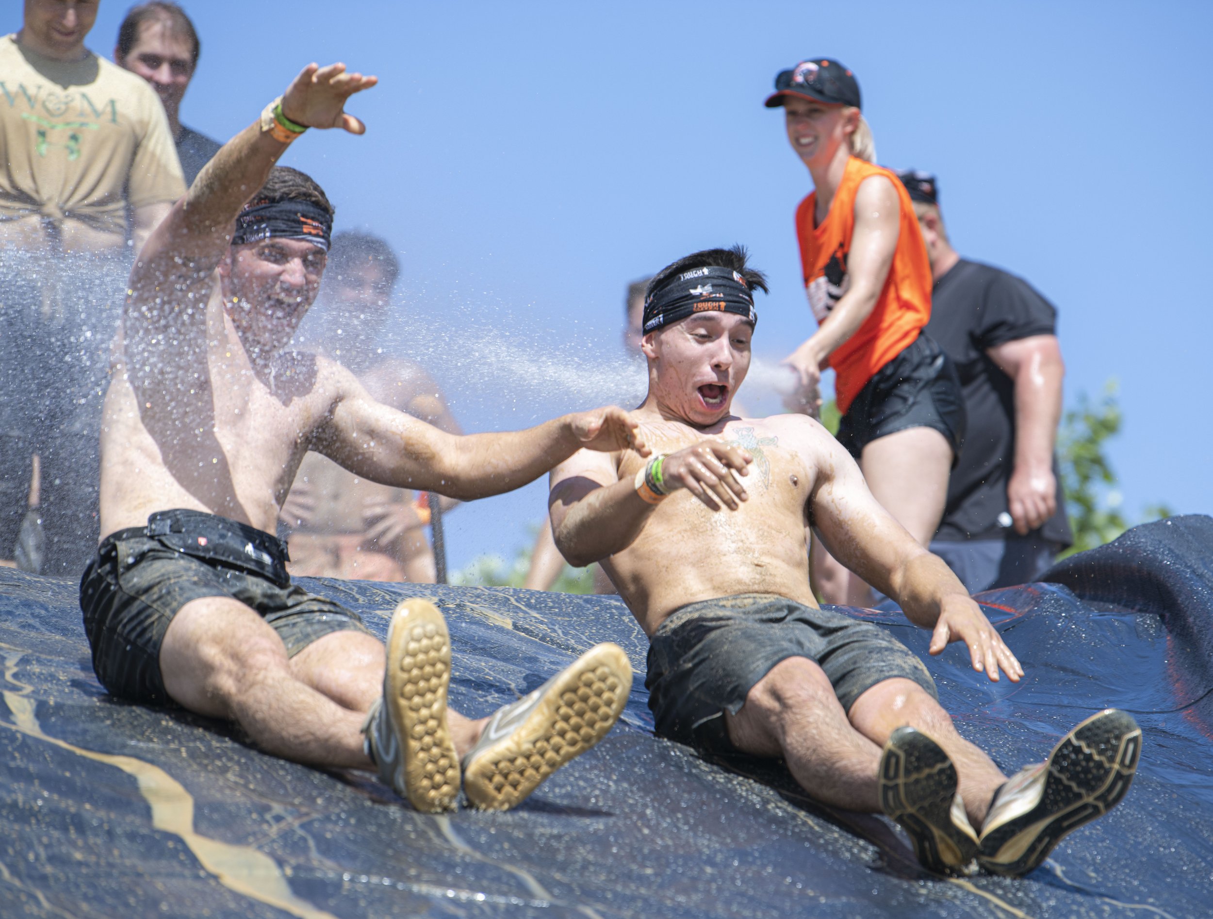  A couple of Tough Mudder Competitors make their way down the mud slide at the Tough Mudder event held in San Bernadino on April 9, 2022. (Jon Putman | The Corsair) 