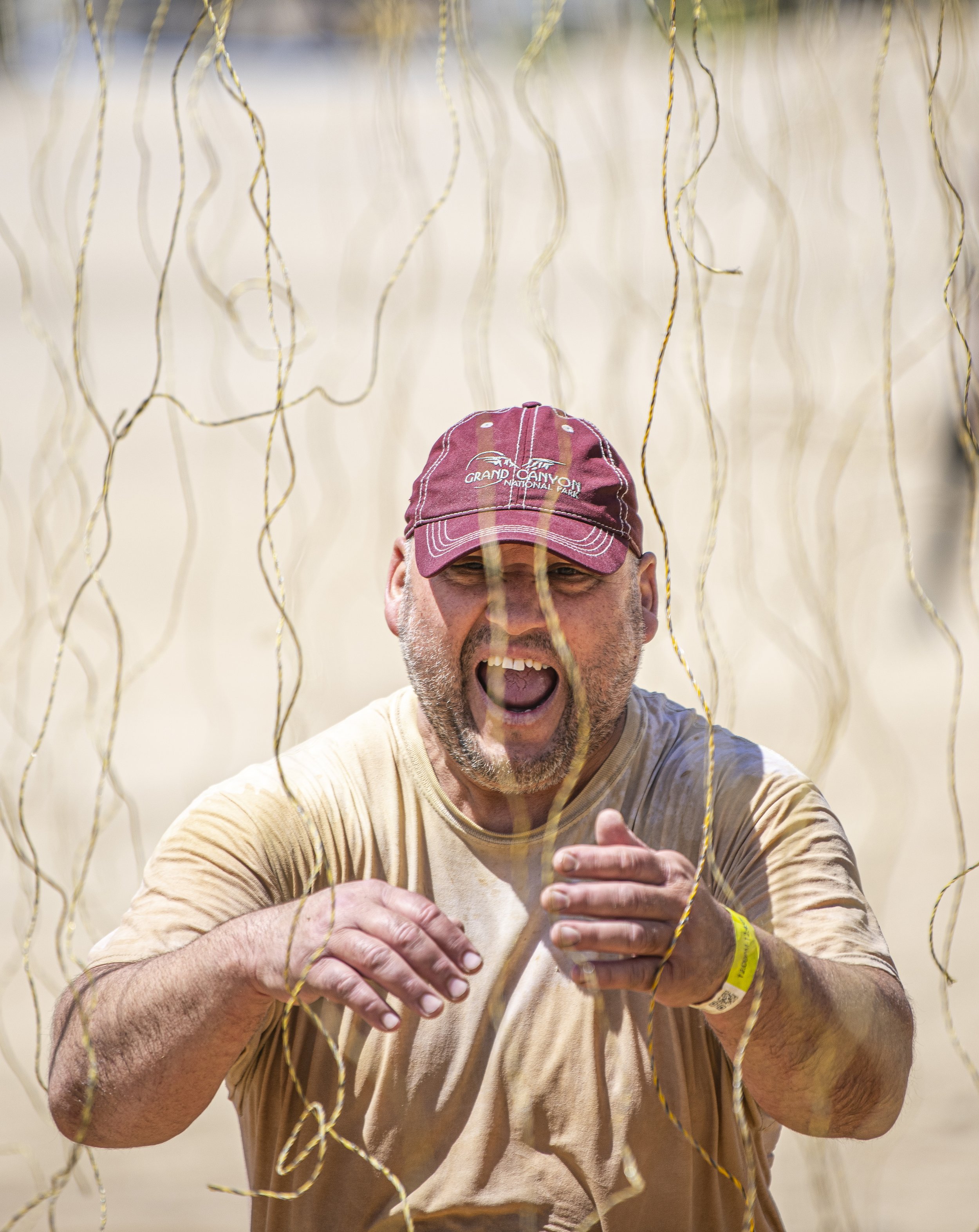  A Tough Mudder Competitor makes his way through the shock wire pit for the final obstacle of the course at the Tough Mudder event held in San Bernadino on April 9, 2022. (Jon Putman | The Corsair) 
