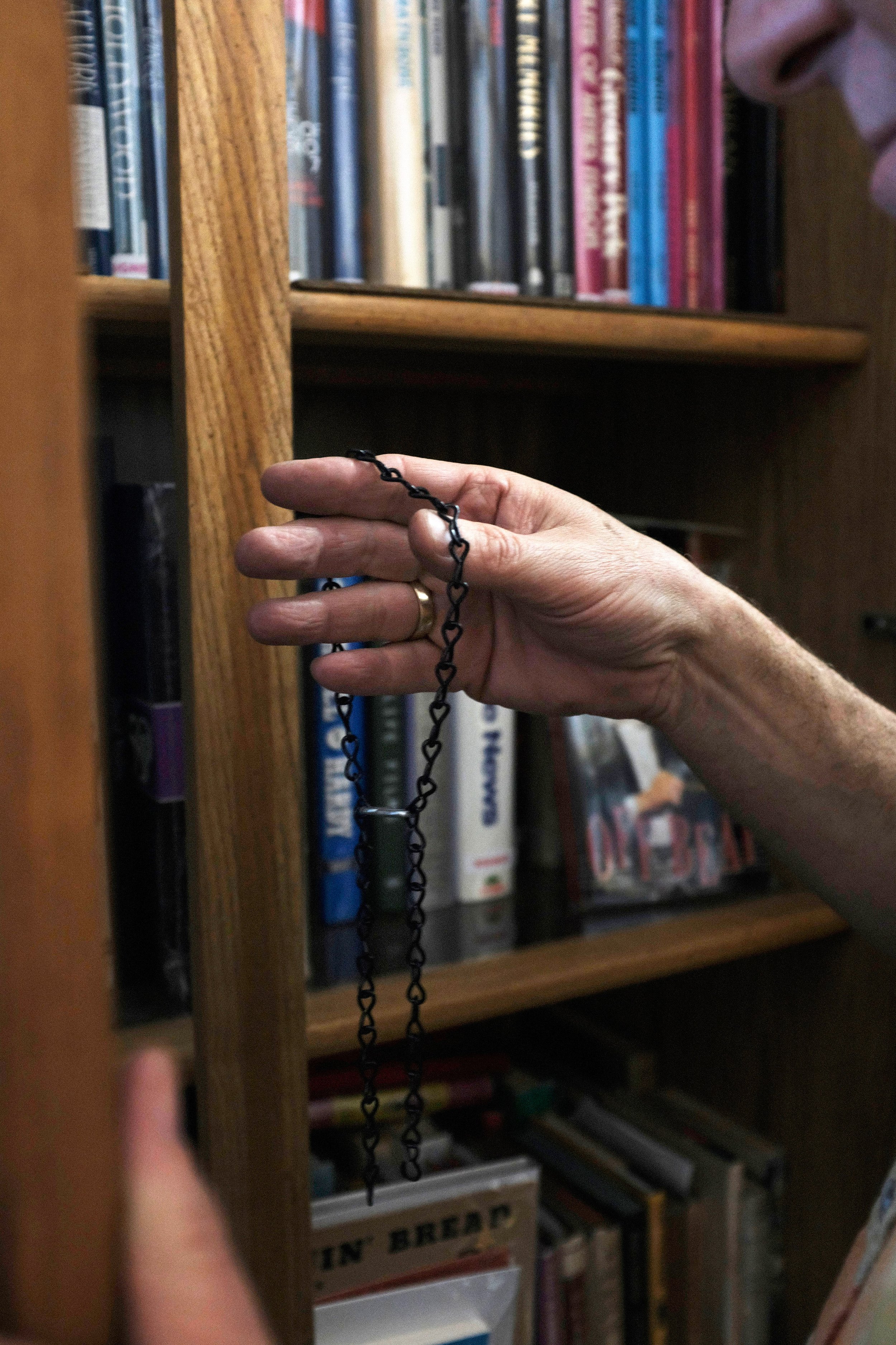  Holding the keys to his locked cases, David Kaye begins to close the door to the collection of books he has finished showing a customer. David Kaye Bookstore and Memorabilia in Woodland Hills, Los Angeles, California on November 26, 2021.(Anna Sophi