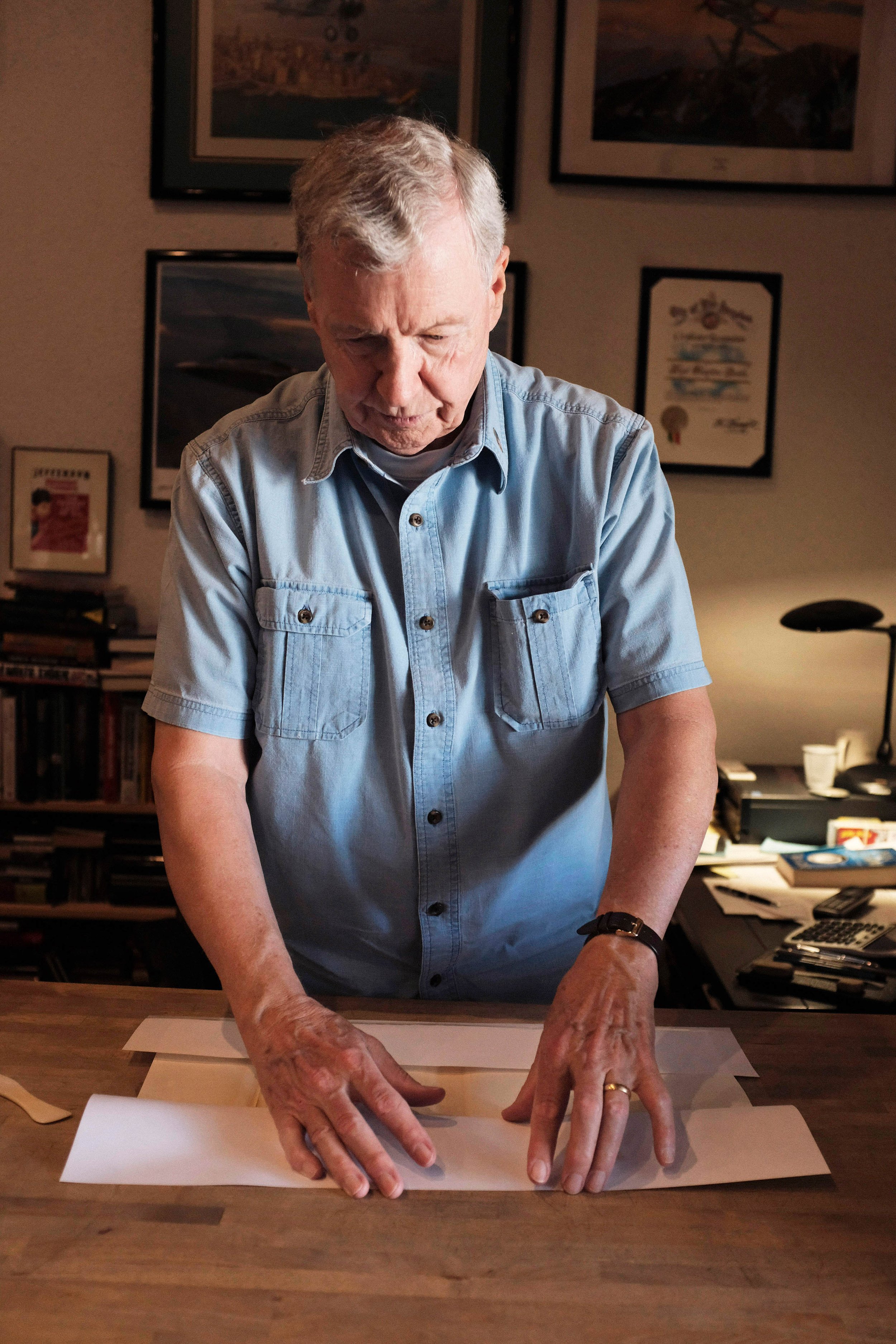  Boyd Davis places a new dust jacket over the tattered cover a book titled The Uncollected Wodehouse. Davis explains his process, sharing that this is “a book that’s in sad shape, and needs to be protected. I love books, and have to preserve them as 